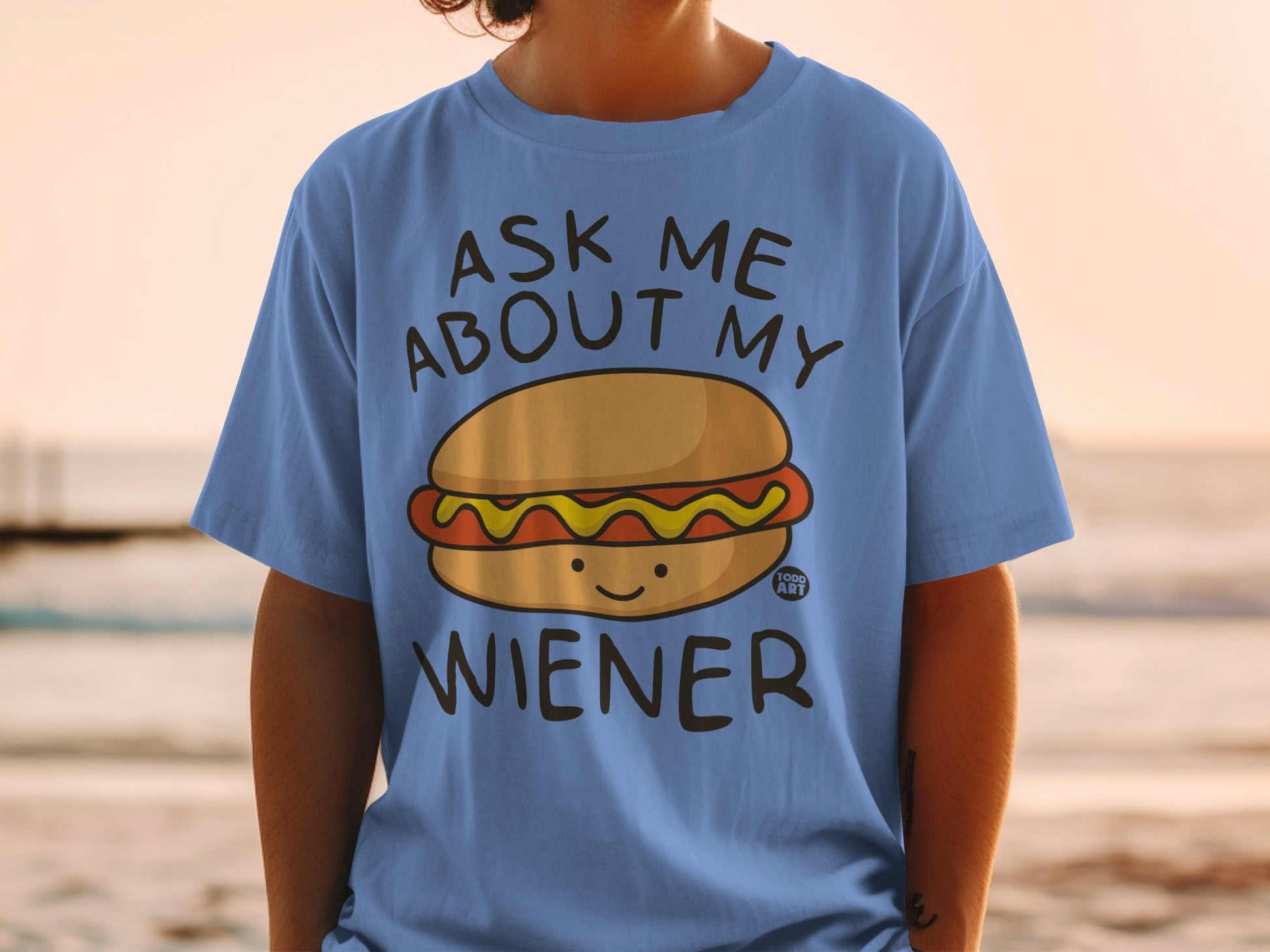 Blue t-shirt with cartoon hot dog and text "ASK ME ABOUT MY WIENER".