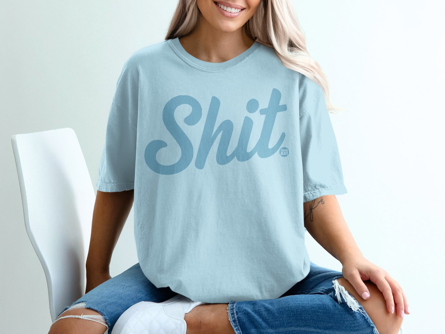 Light blue t-shirt with "Shit Show" text design.