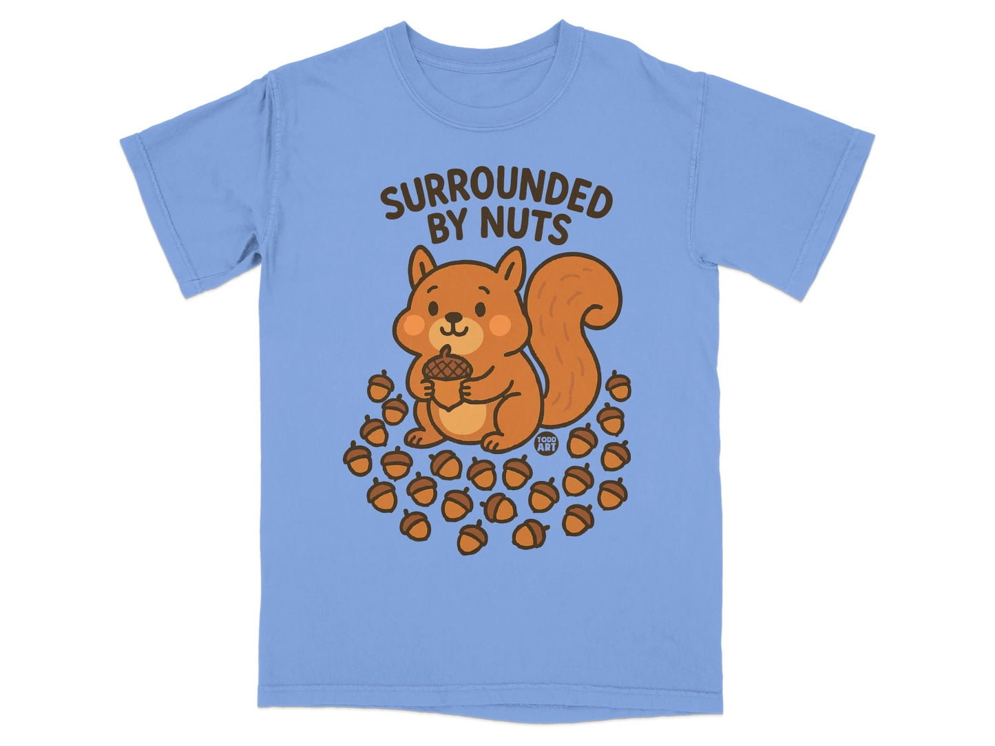 Cartoon squirrel holding acorn, surrounded by many acorns, on blue t-shirt.