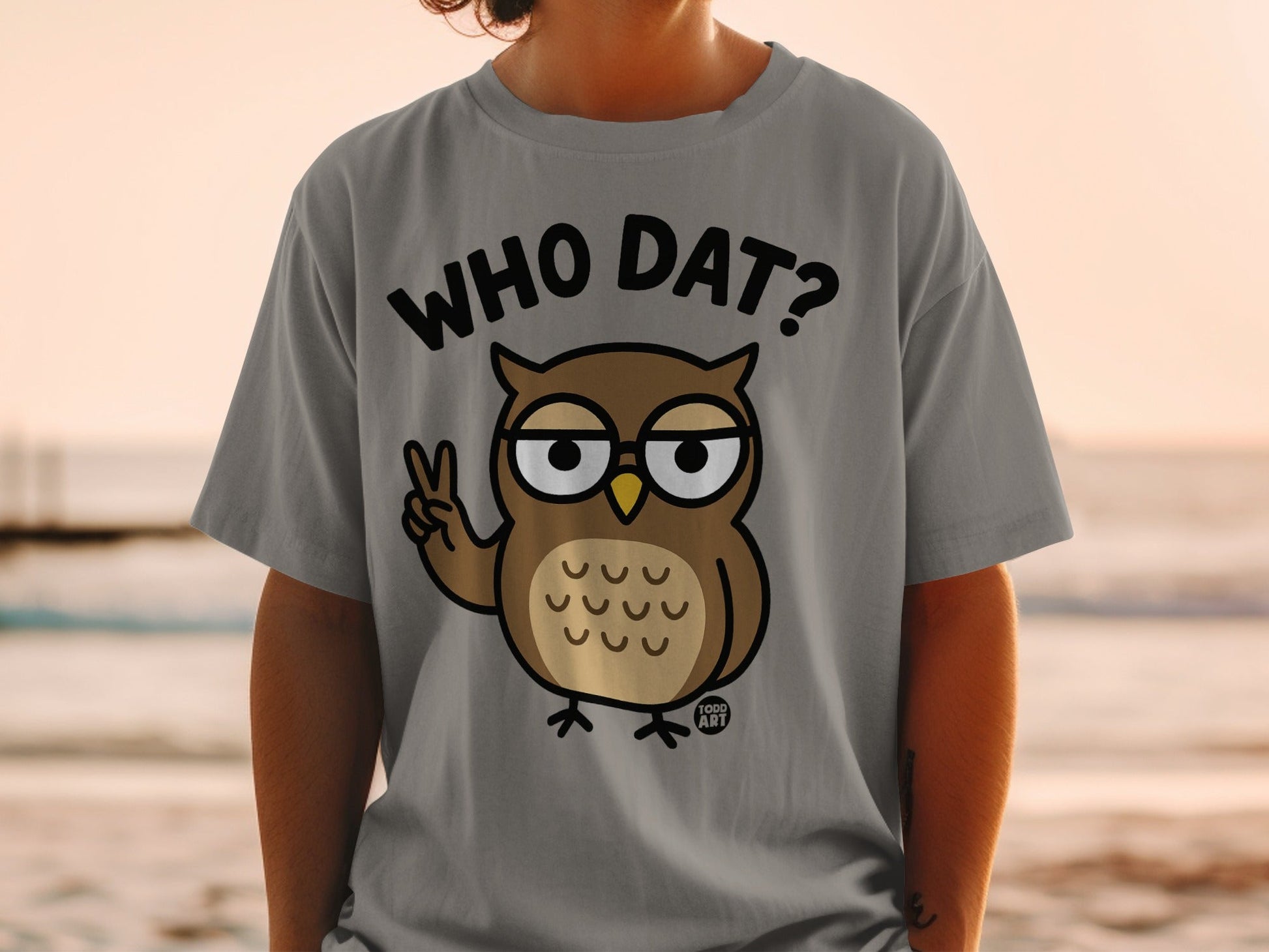 Grey t-shirt with cartoon owl giving peace sign and text "WHO DAT?"