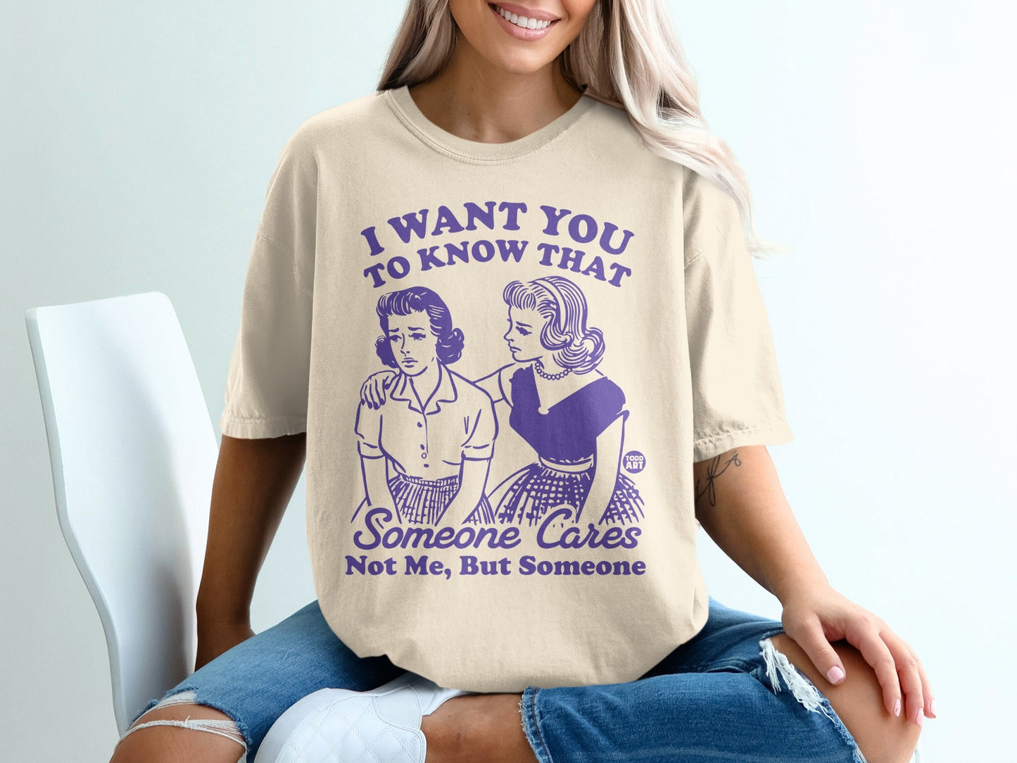 T-shirt with purple text: "I WANT YOU TO KNOW THAT SOMEONE CARES. Not Me, But Someone."