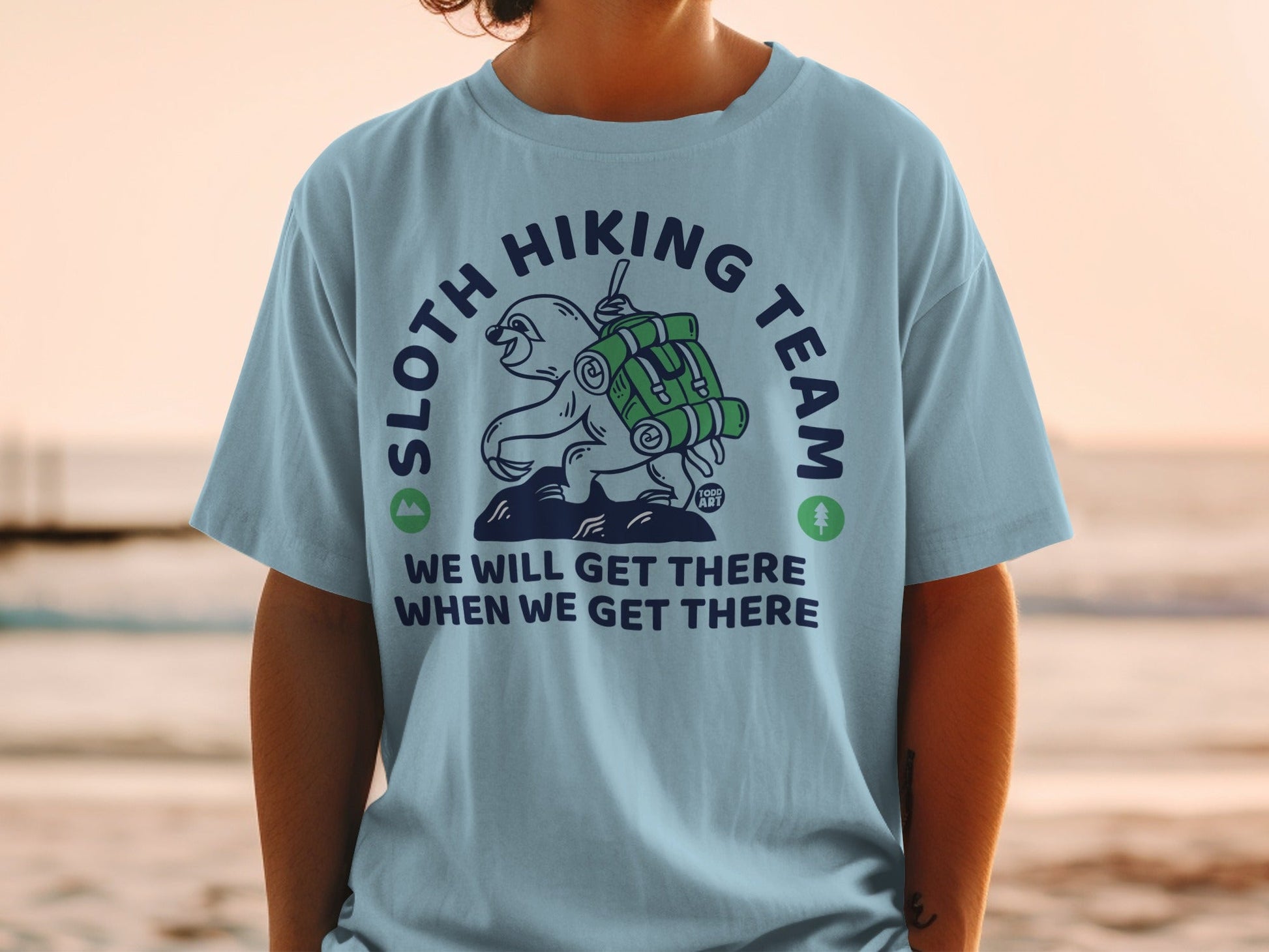 Light blue t-shirt with sloth hiking team graphic and text.