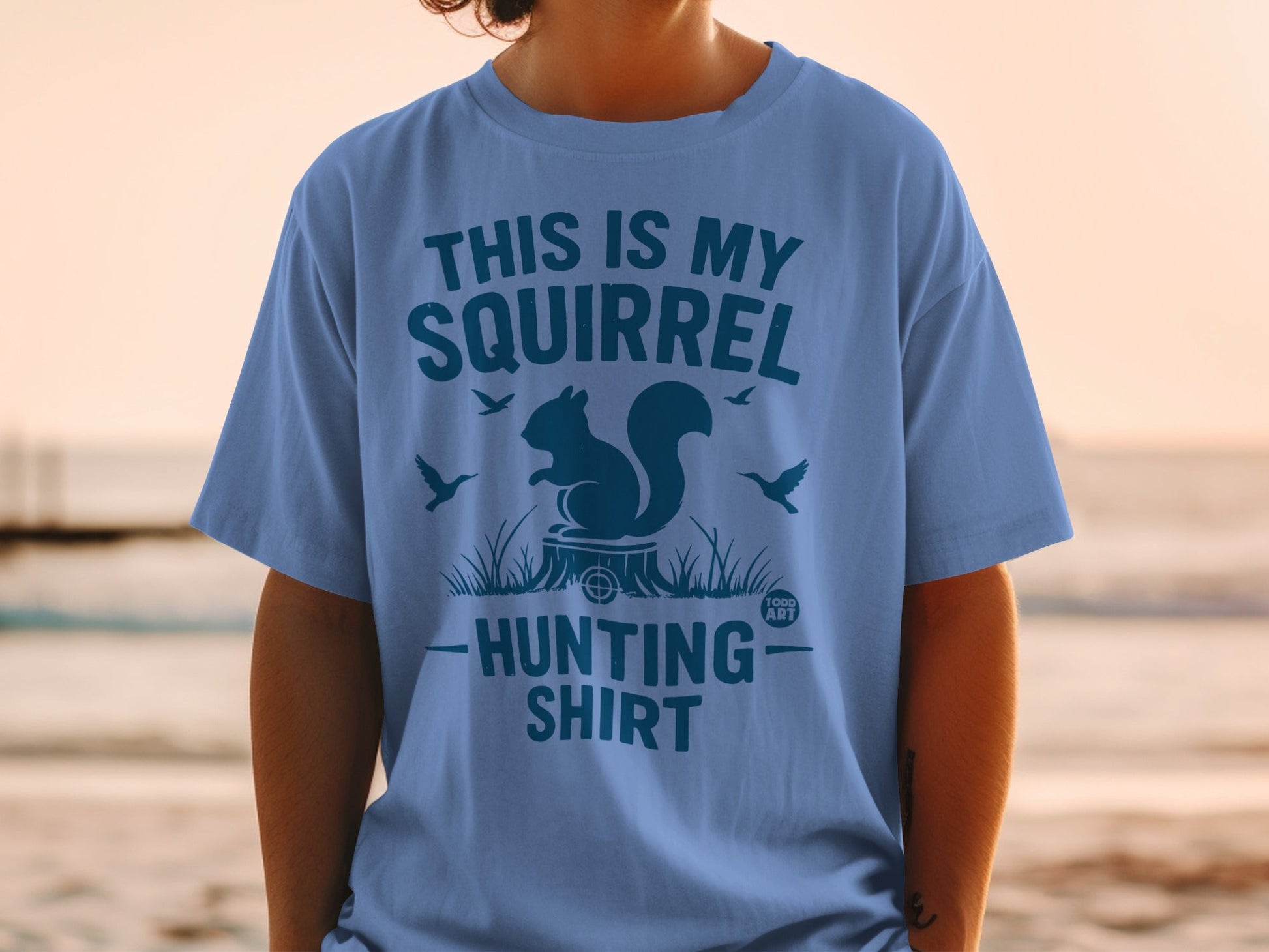 Blue t-shirt with "This Is My Squirrel Hunting Shirt" text and squirrel graphic.