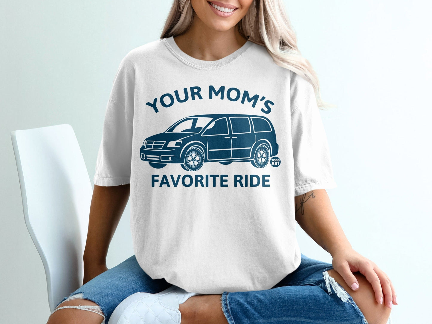 White t-shirt with dark blue text "YOUR MOM'S FAVORITE RIDE" and a van graphic.