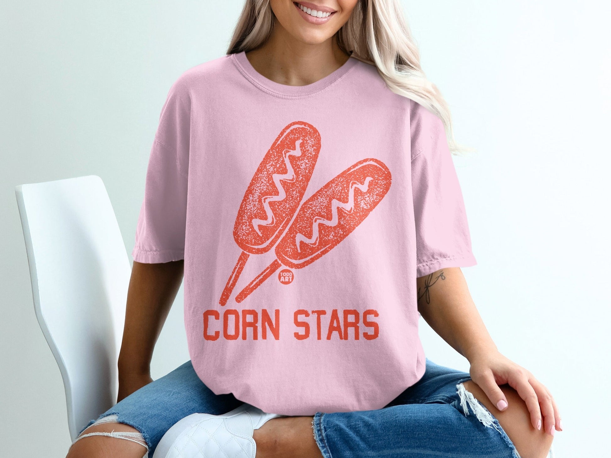 Pink t-shirt with corn dog graphic and "CORN STARS" text.