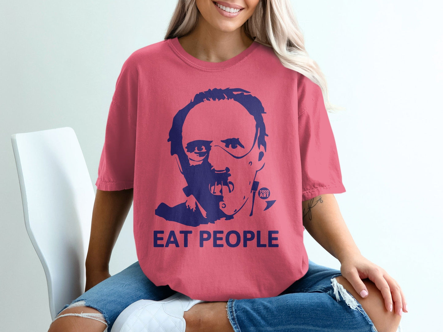 Pink t-shirt with dark blue graphic of Hannibal Lecter and "EAT PEOPLE" text.
