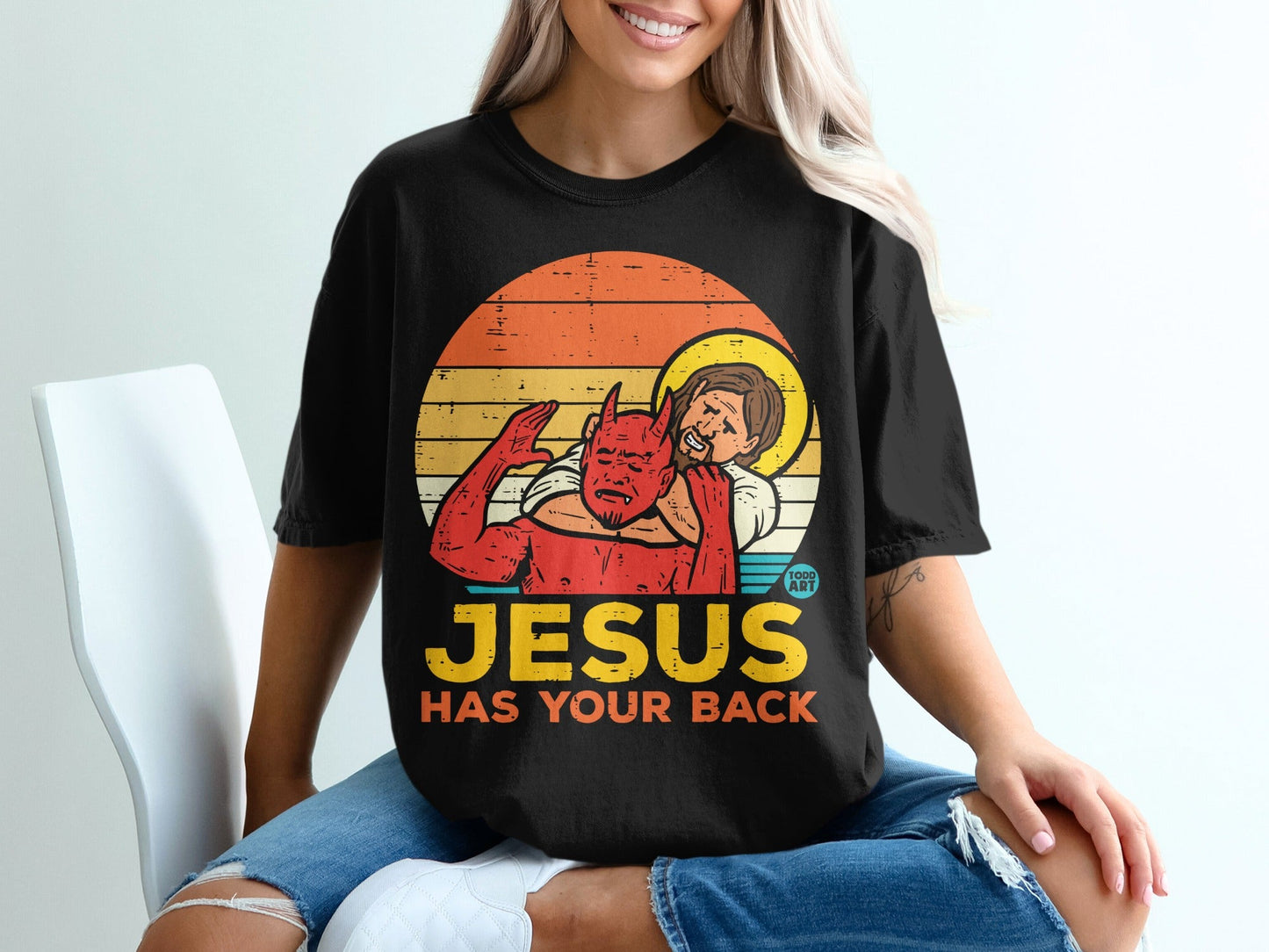 Jesus embracing a devil figure with text "JESUS HAS YOUR BACK".