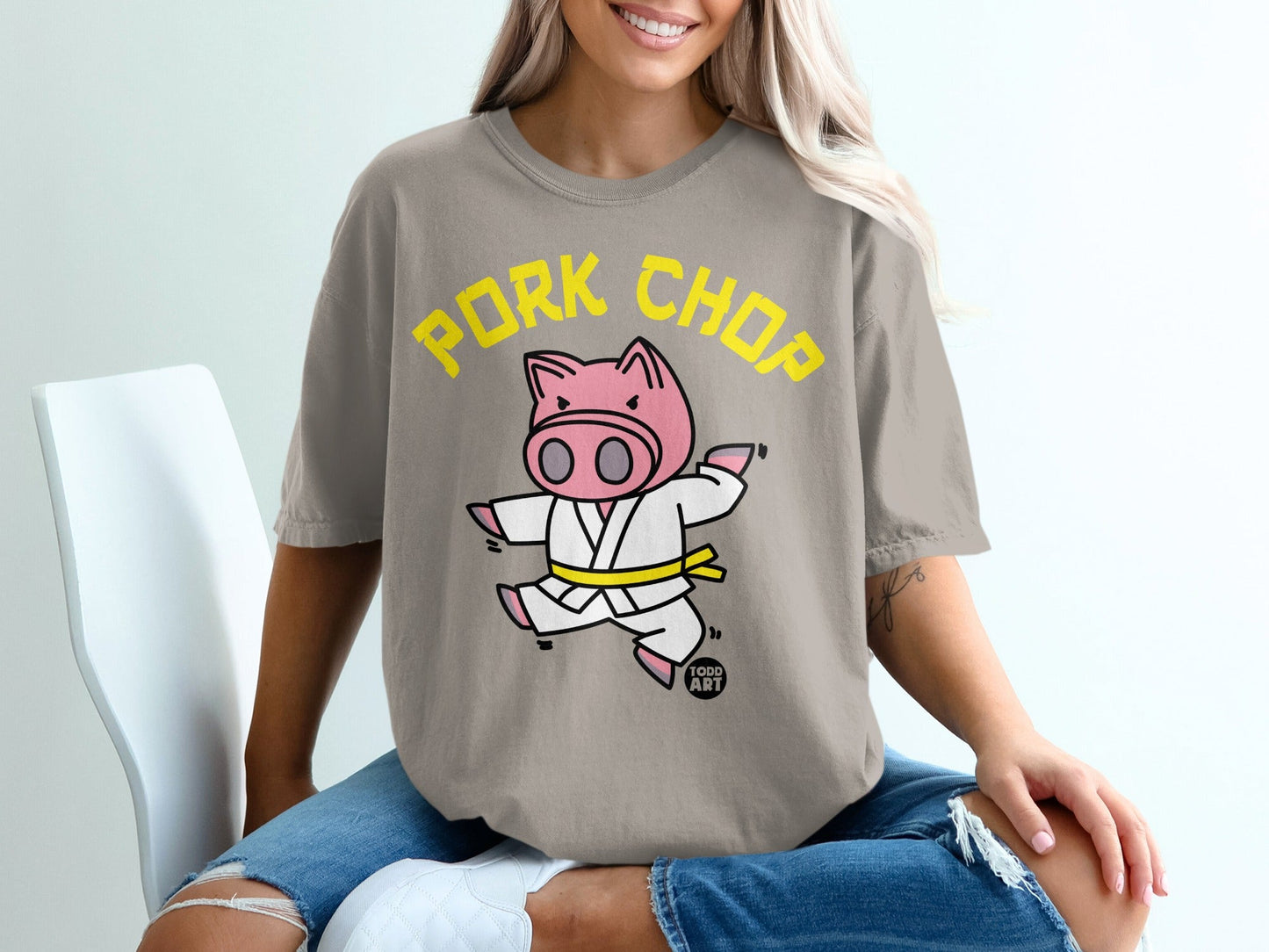 Cartoon pig in karate gi with yellow belt, "Pork Chop" text.