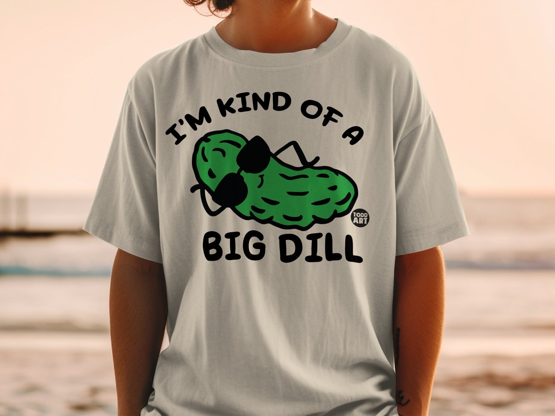 Gray t-shirt with "I'M KIND OF A BIG DILL" and cartoon pickle wearing sunglasses.