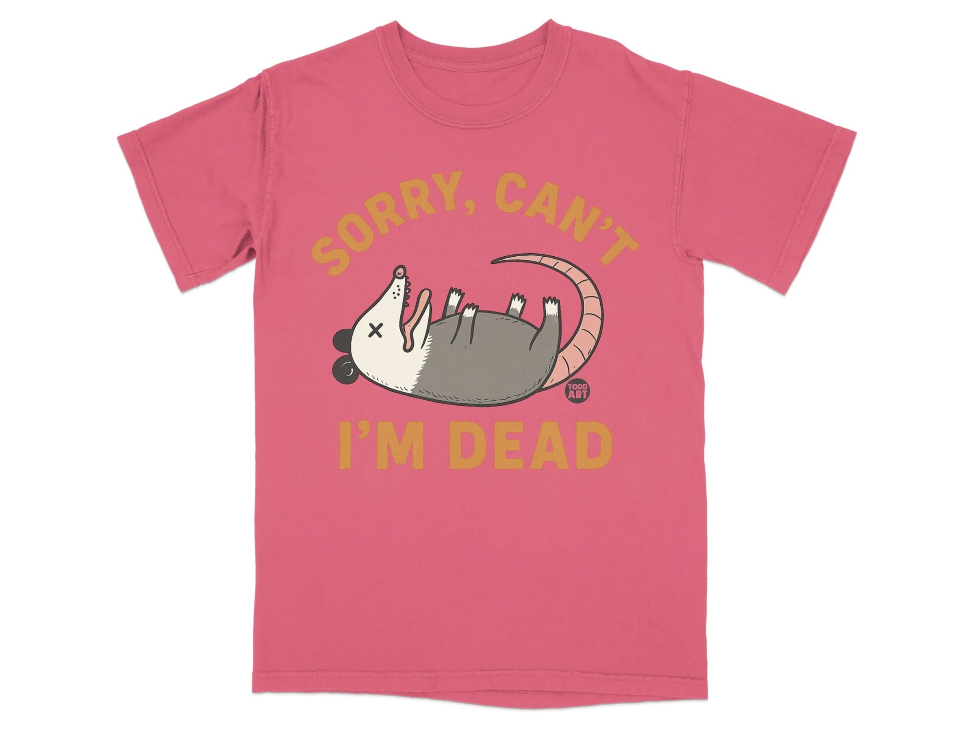 Pink t-shirt with a cartoon opossum playing dead and text "SORRY, CAN'T I'M DEAD".