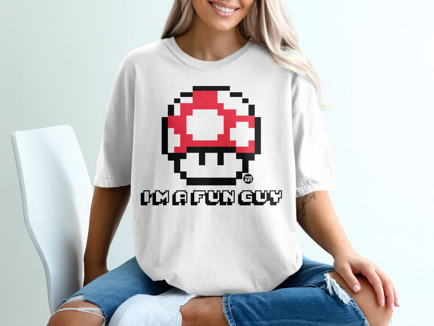 White t-shirt with pixelated red and white mushroom and "I'M A FUN GUY" text.