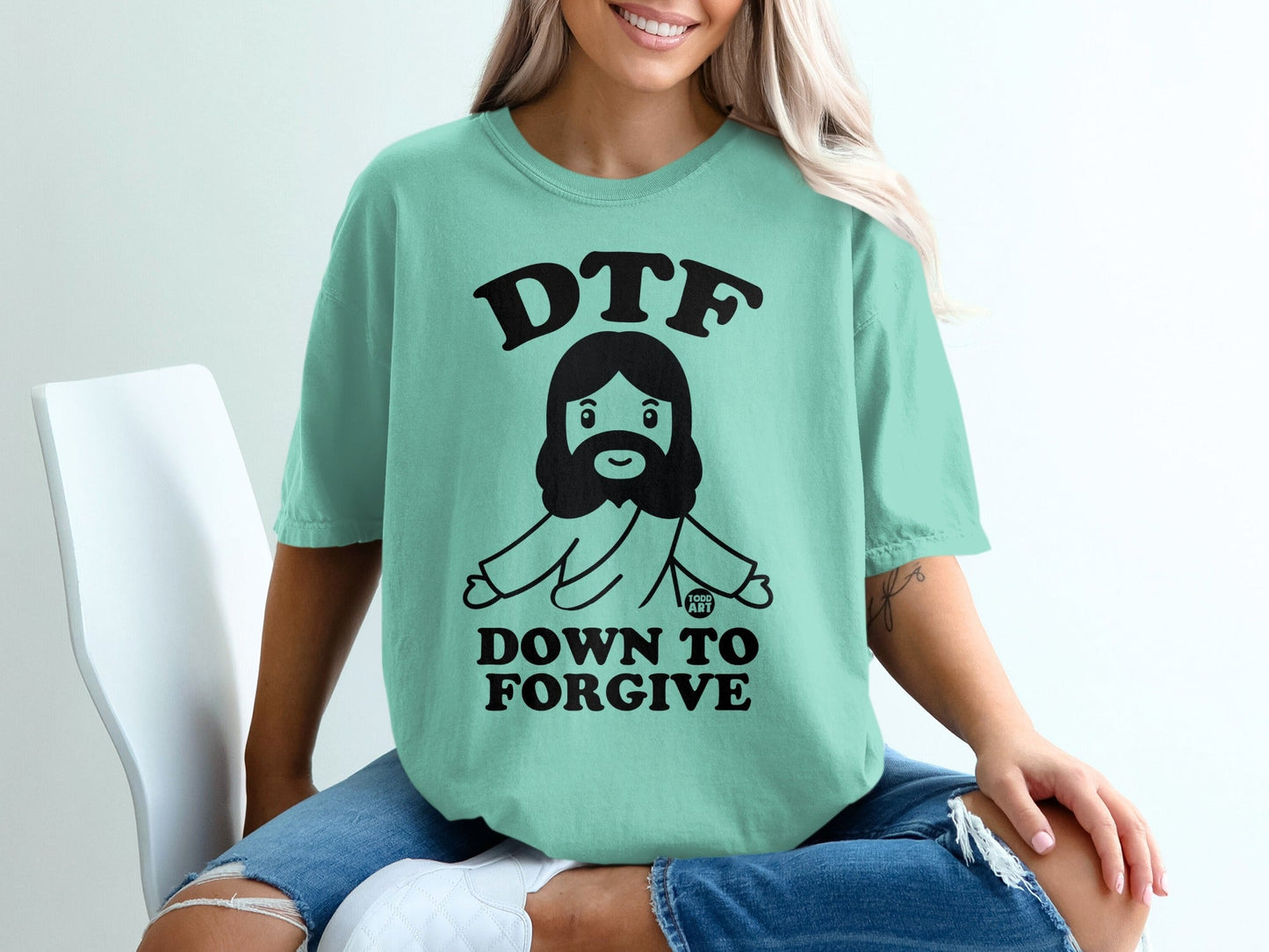 Teal t-shirt with "DTF DOWN TO FORGIVE" and a cartoon Jesus graphic.