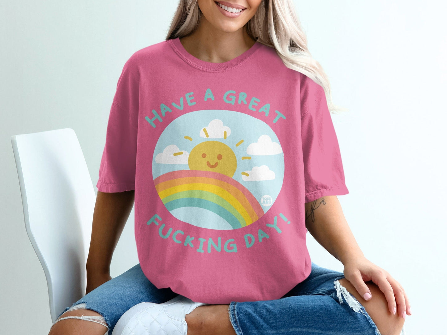 Pink t-shirt with sun, rainbow, and "Have a Great Fucking Day!" text.