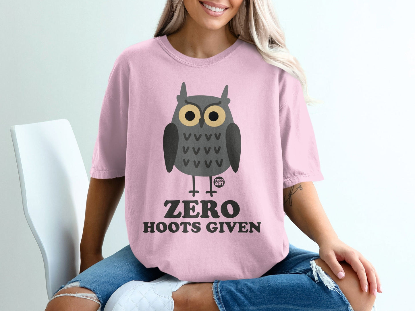 Pink t-shirt with an owl graphic and the text "ZERO HOOTS GIVEN".
