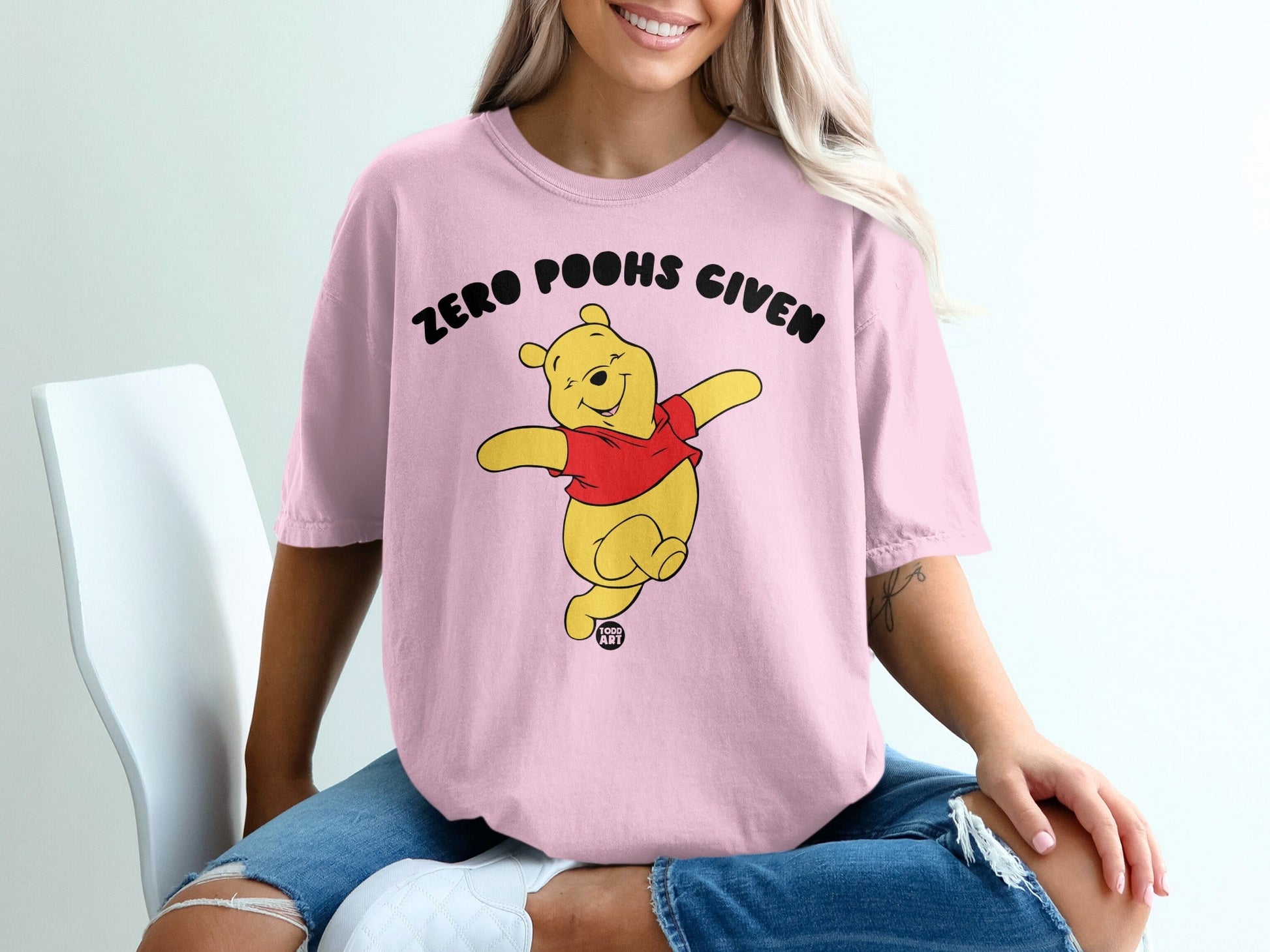 Winnie the Pooh wearing a pink t-shirt with "ZERO POOHS GIVEN" text.