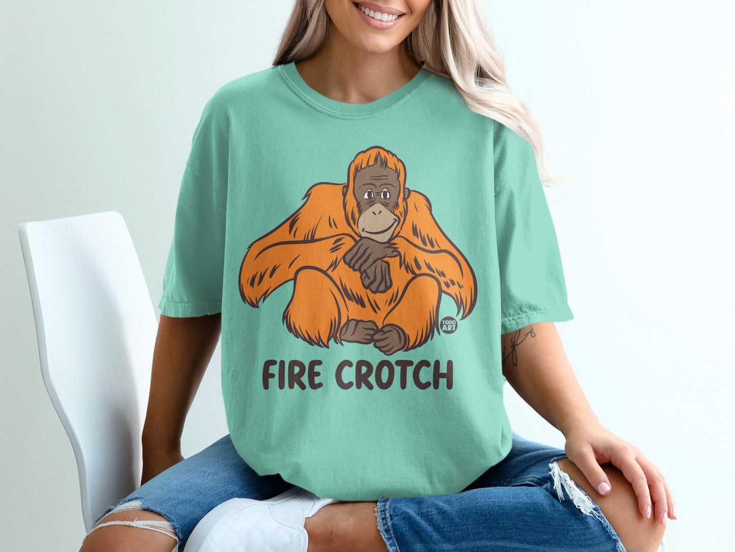 Mint t-shirt with an illustration of a seated orangutan and the text "FIRE CROTH".