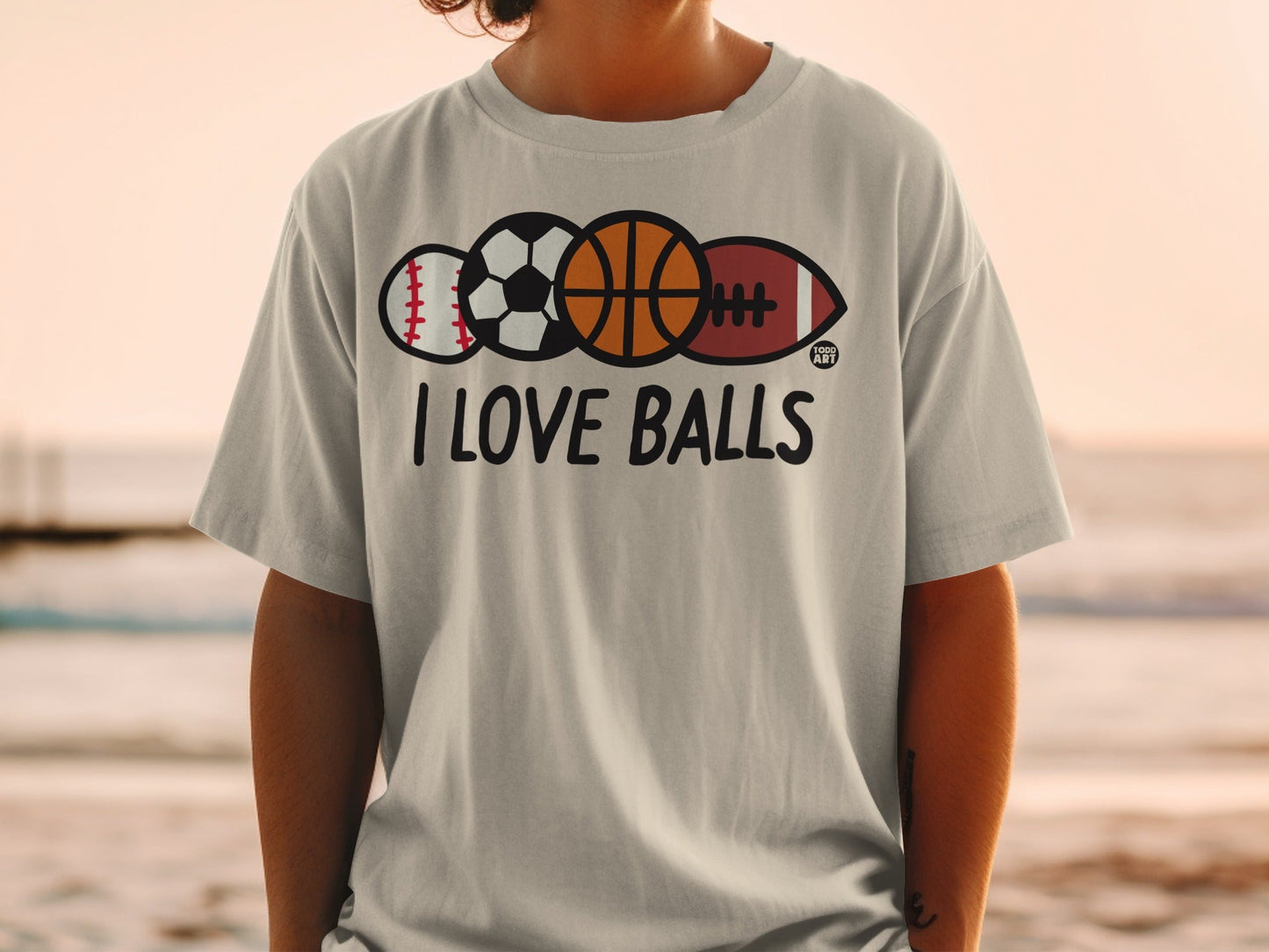 Grey t-shirt with "I LOVE BALLS" text and sports balls graphic.