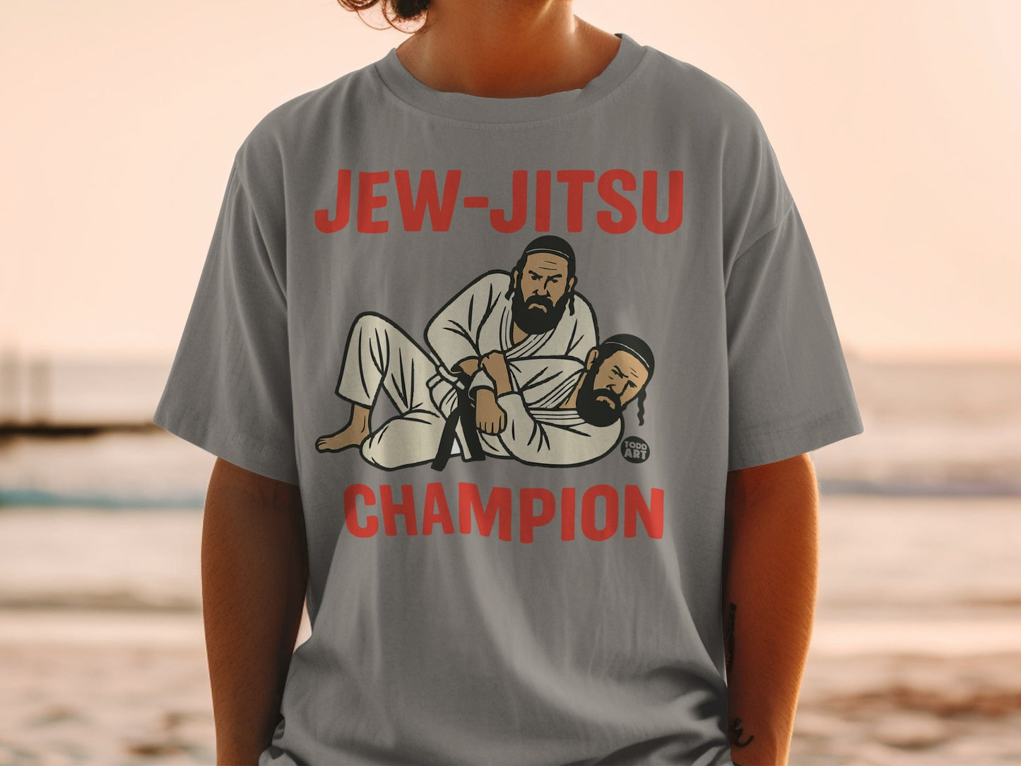 Two men in Jewish attire grappling on a gray t-shirt.