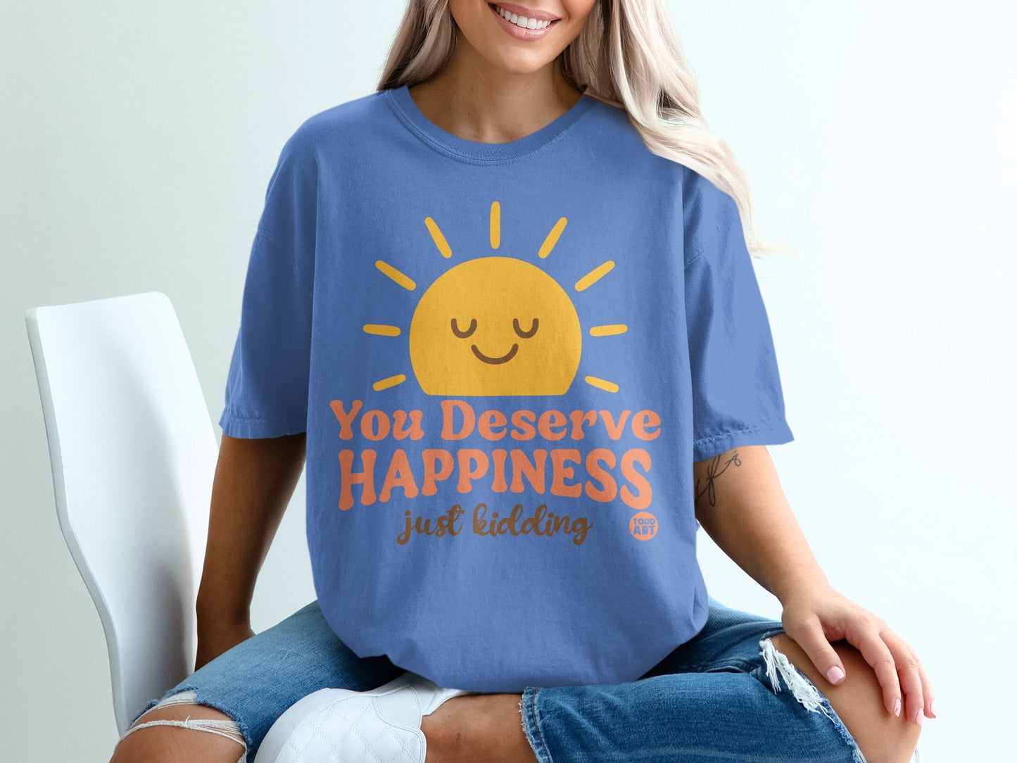 Blue t-shirt with smiling sun graphic and text "You Deserve Happiness, just kidding".