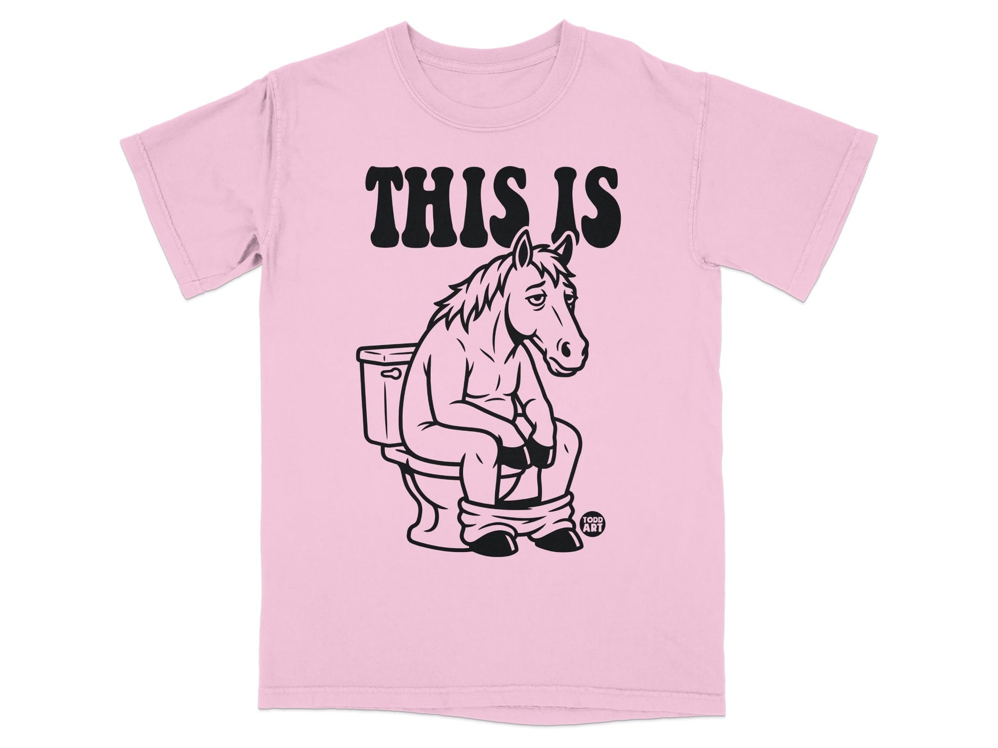 Pink t-shirt with a cartoon horse sitting on a toilet, text "THIS IS".
