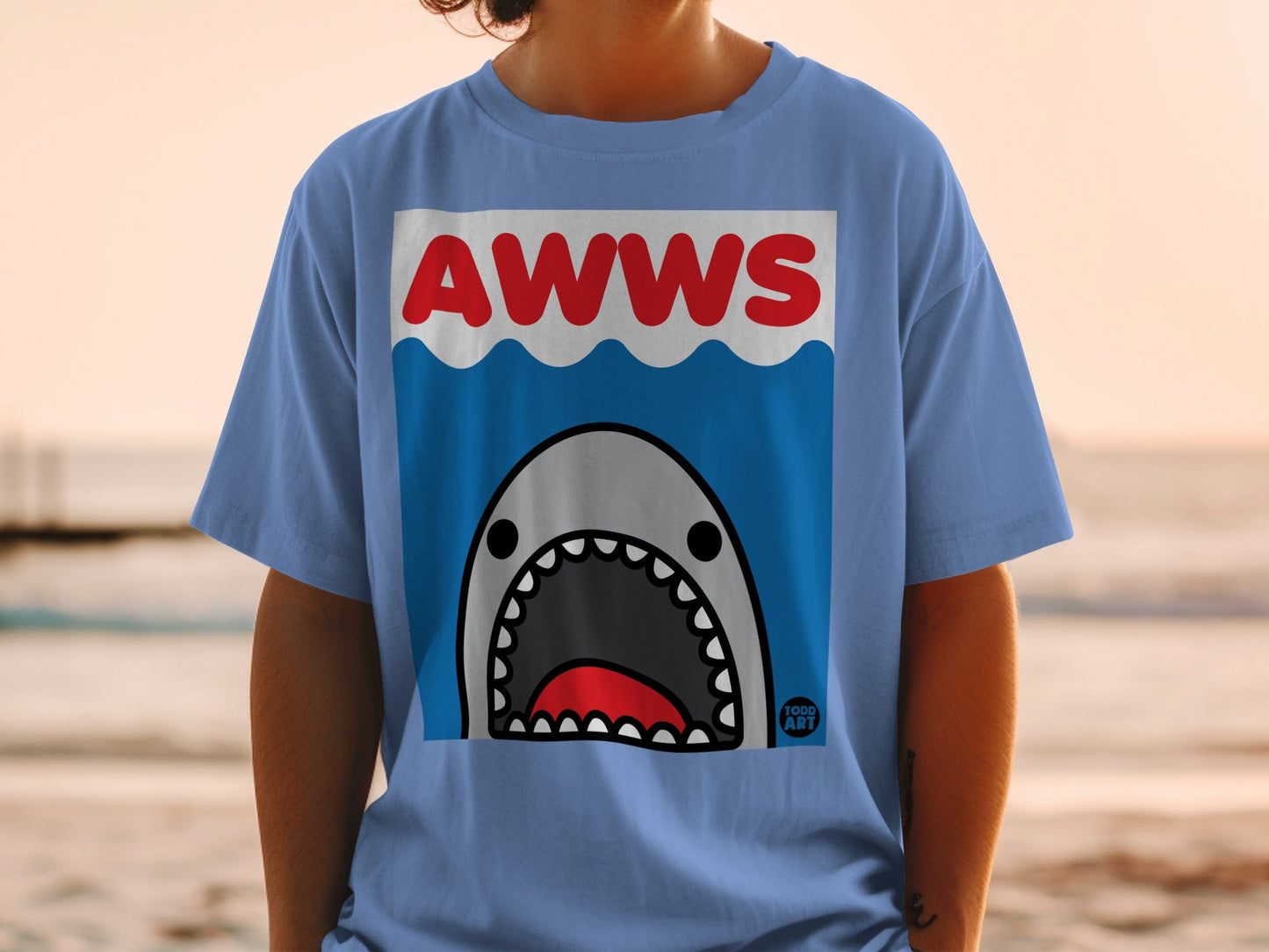 Shirt with "AWWS" text and cartoon shark mouth over blue waves.