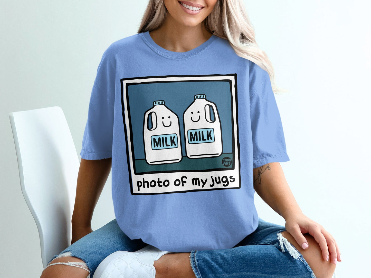 Blue t-shirt with cartoon milk jugs and "photo of my jugs" text.