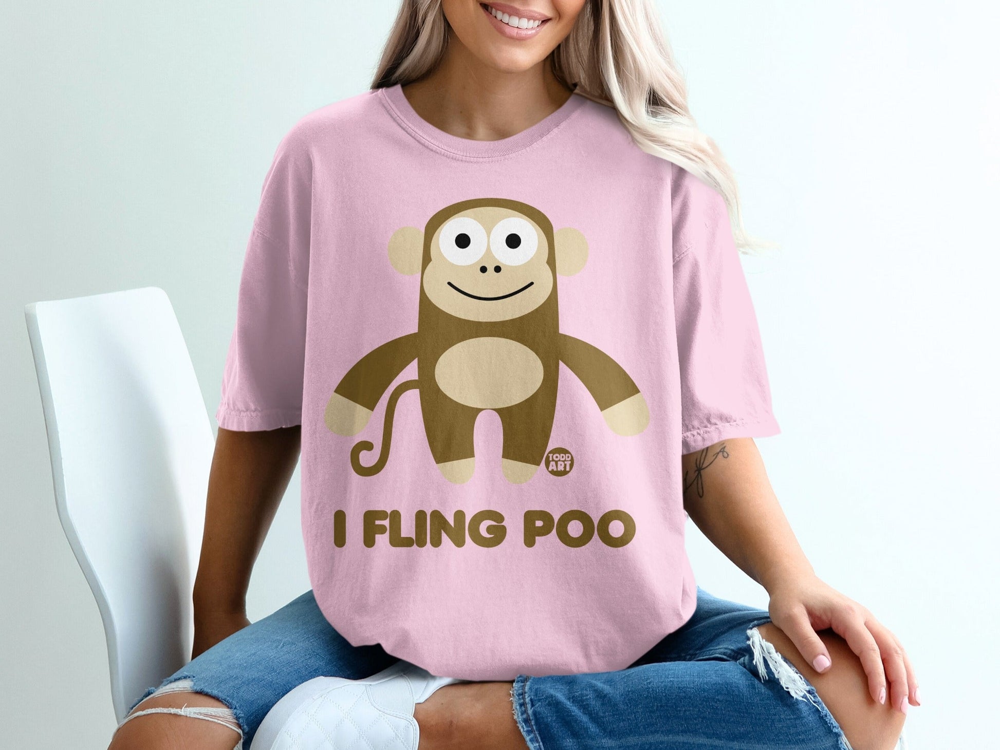 Pink t-shirt with "I fling poo" text and cartoon monkey graphic.