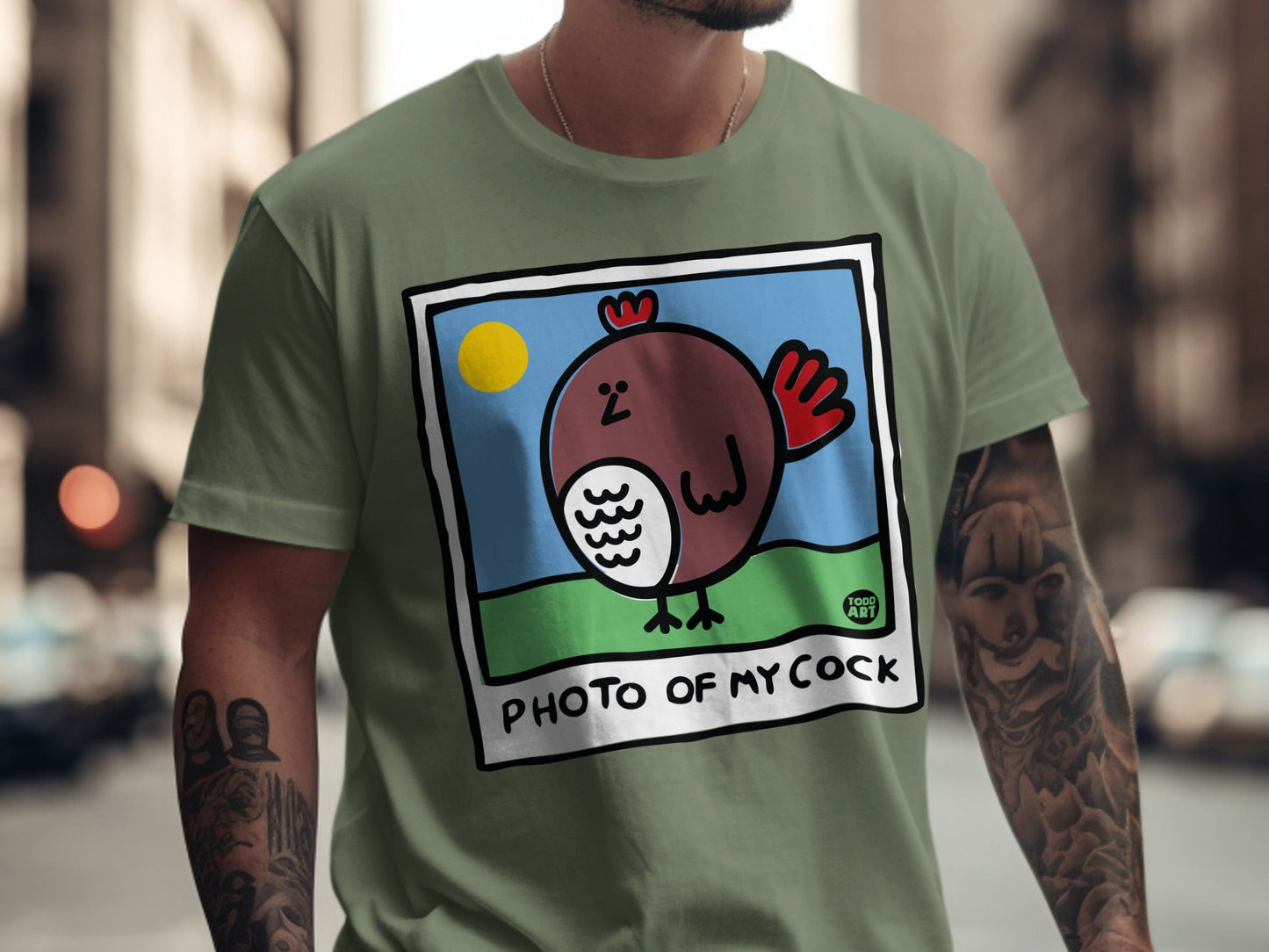 Green t-shirt with a cartoon chicken and "PHOTO OF MY COCK" text.
