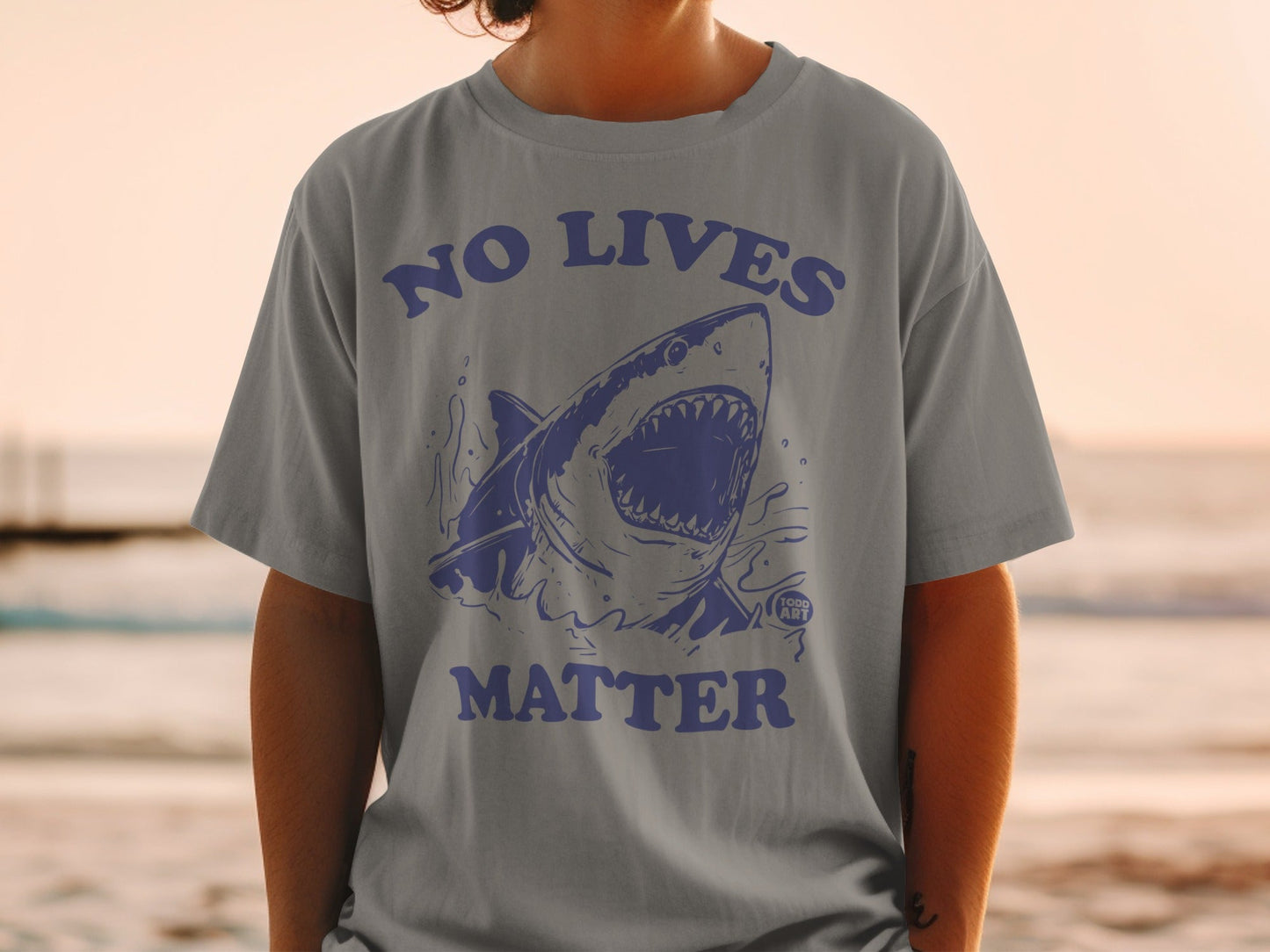 Gray t-shirt with blue shark graphic and "NO LIVES MATTER" text.
