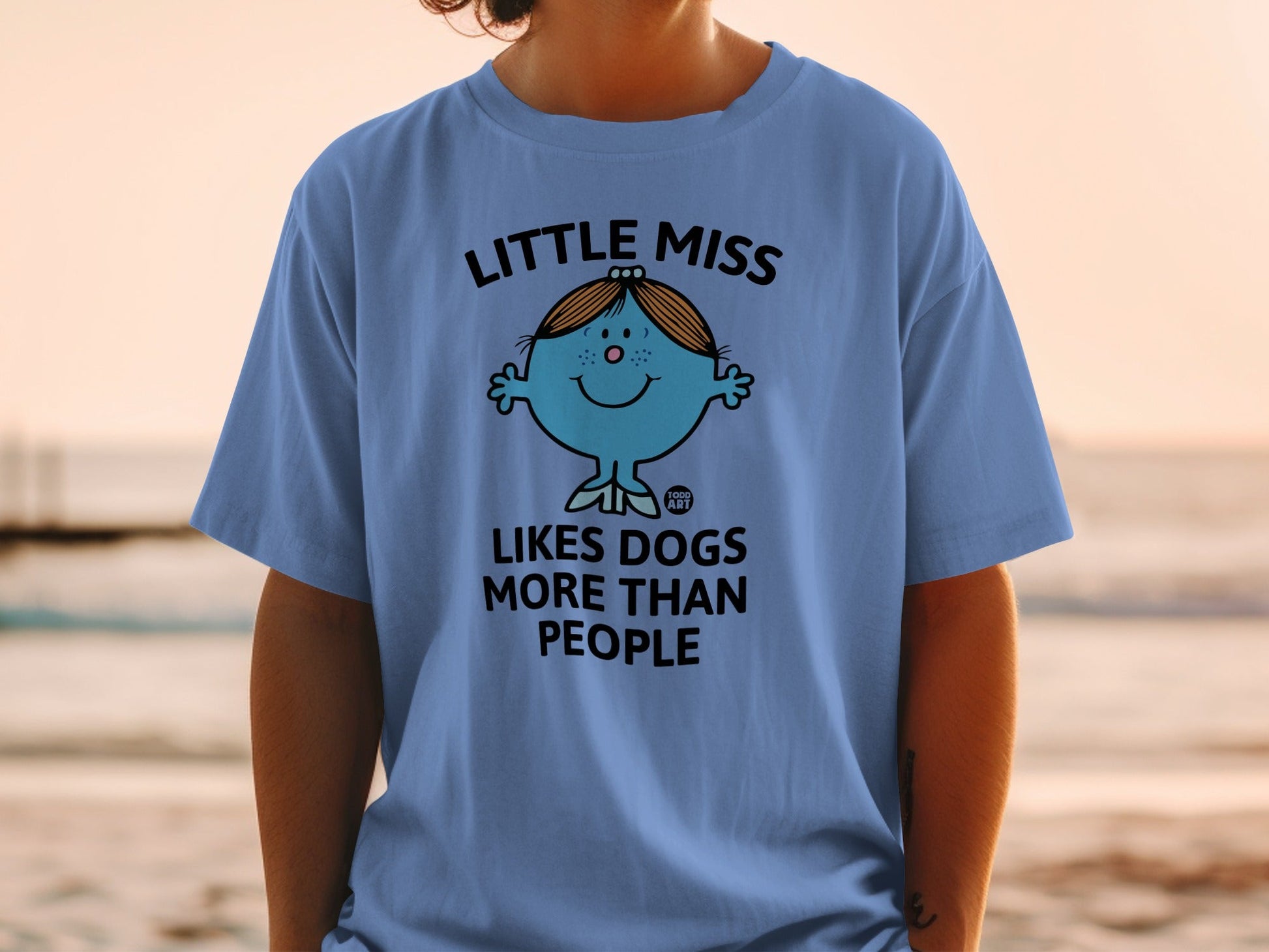Blue t-shirt with "Little Miss Likes Dogs More Than People" text and cartoon.