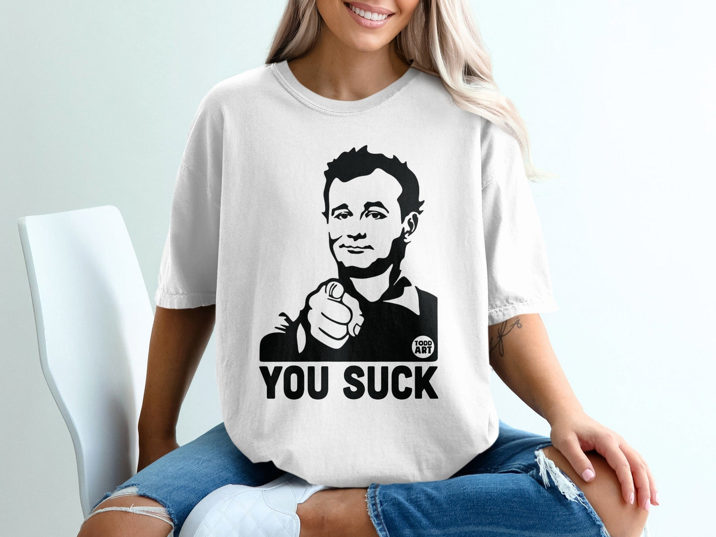 T-shirt with black graphic of Bill Murray pointing and text "YOU SUCK".