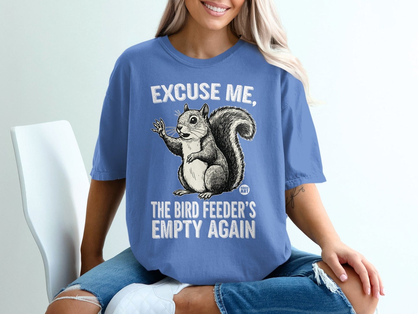 T-shirt with squirrel graphic and text "Excuse me, the bird feeder's empty again".