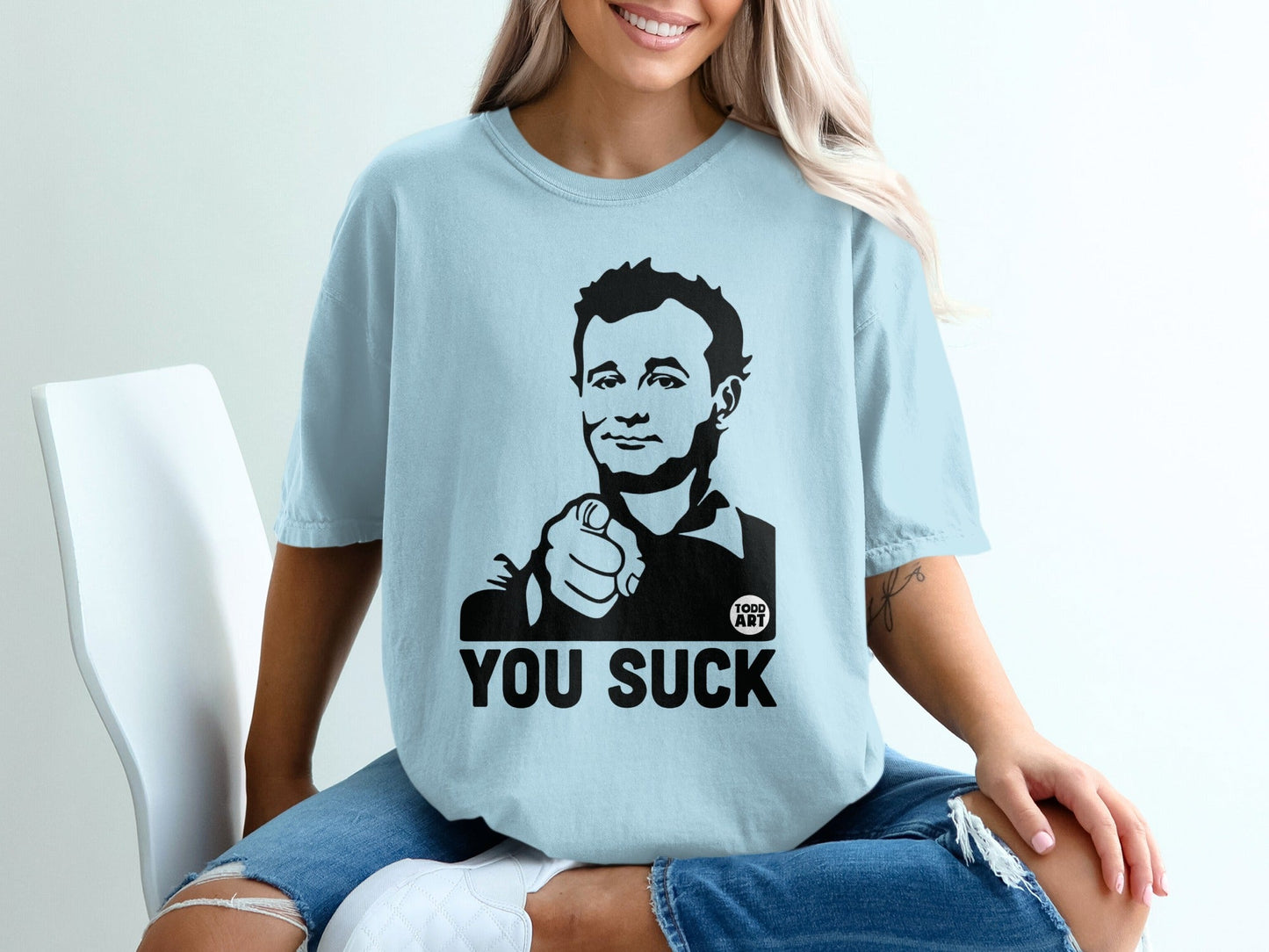Light blue t-shirt with Bill Murray graphic and "YOU SUCK" text.