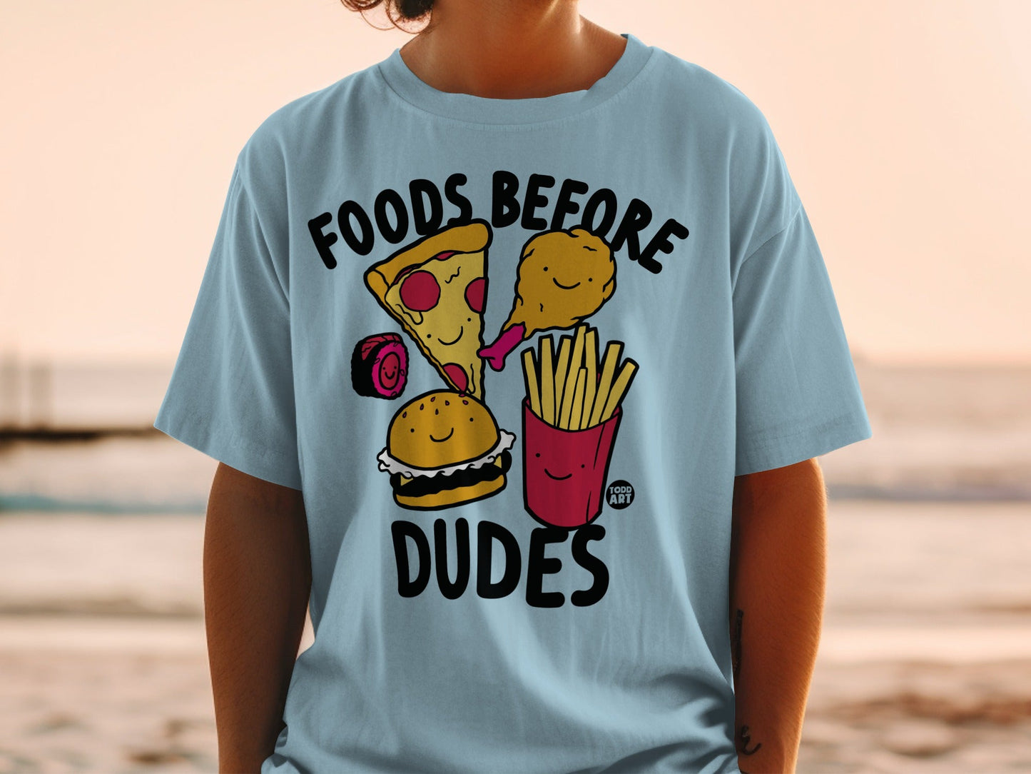 T-shirt with cartoon pizza, burger, fries, and chicken leg with "FOODS BEFORE DUDES" text.