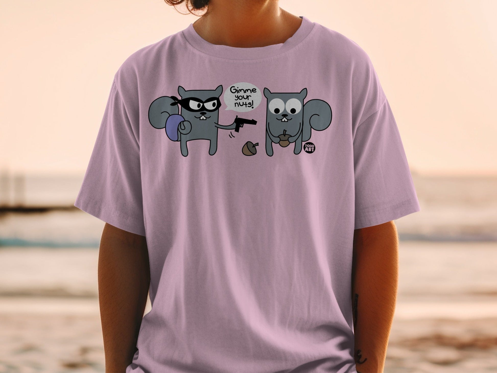 Two cartoon squirrels, one with a gun, the other holding nuts, on a t-shirt.