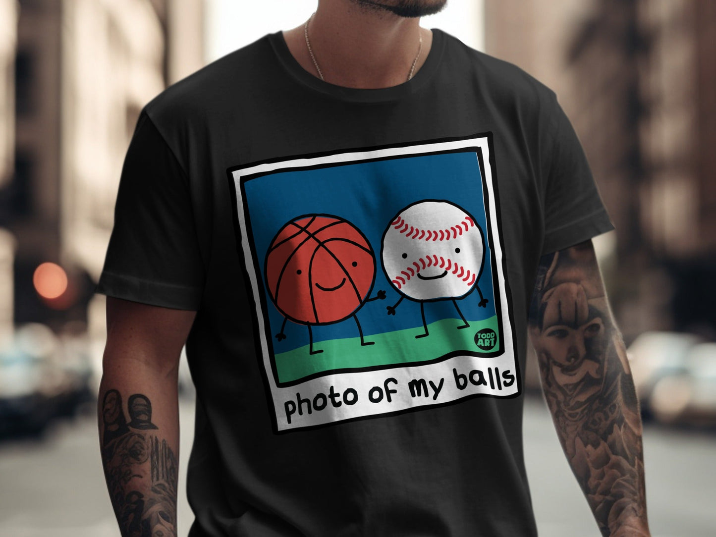 T-shirt featuring cartoon basketball and baseball with "photo of my balls" text.