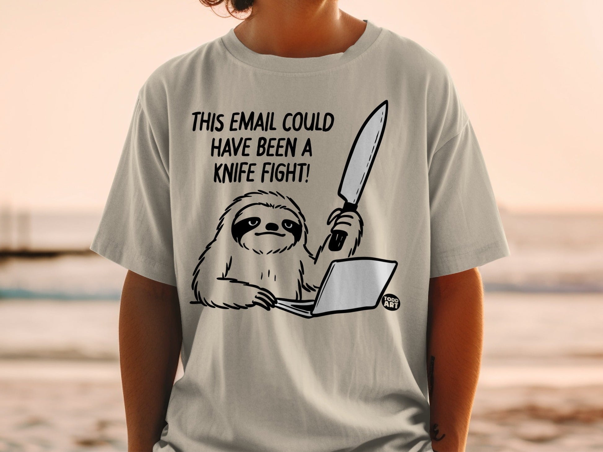 T-shirt graphic of a sloth at a laptop holding a knife, text says "This email could have been a knife fight."