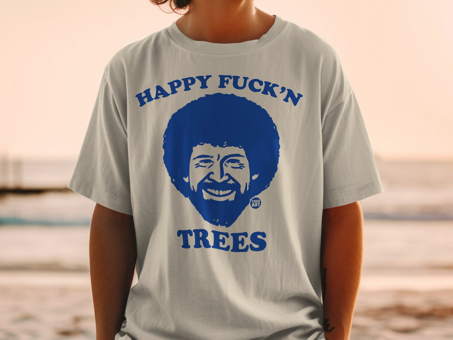 T-shirt with Bob Ross face and "HAPPY FUCK'N TREES" text.