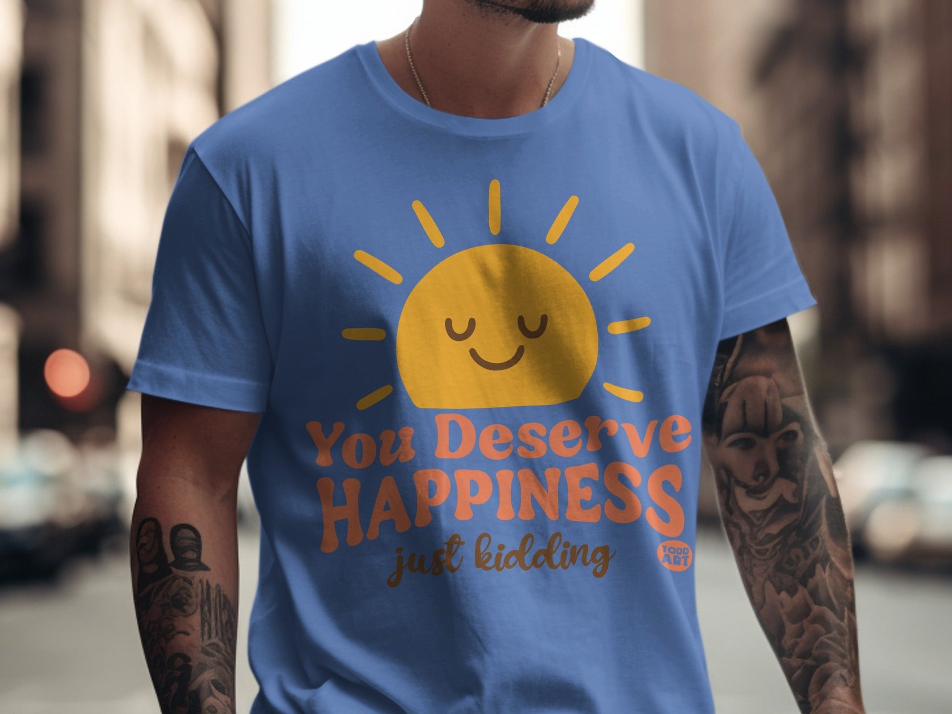 Blue t-shirt with a smiling sun and "You Deserve Happiness just kidding" text.