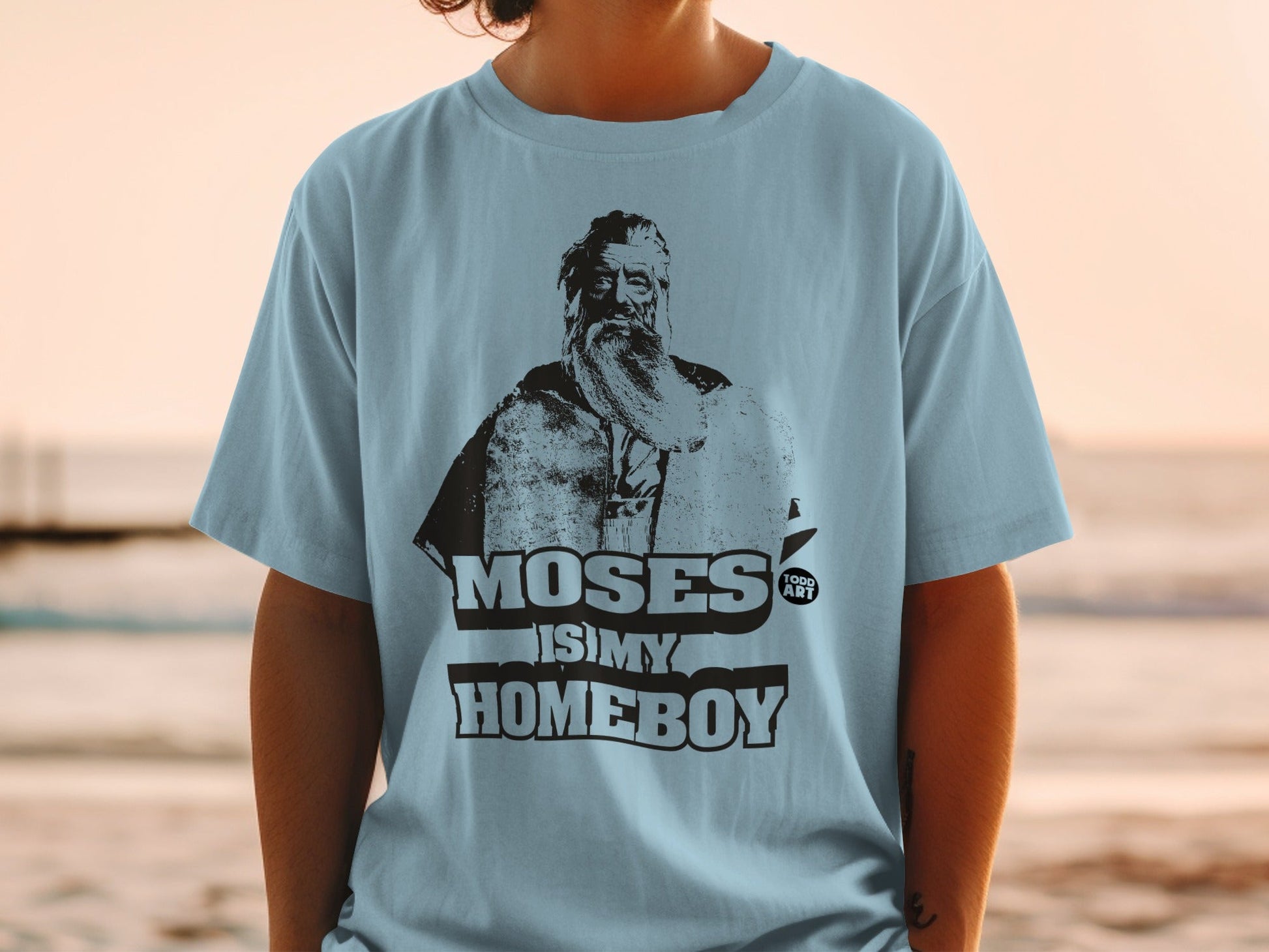 Light blue t-shirt featuring Moses illustration and "Moses is my homeboy" text.