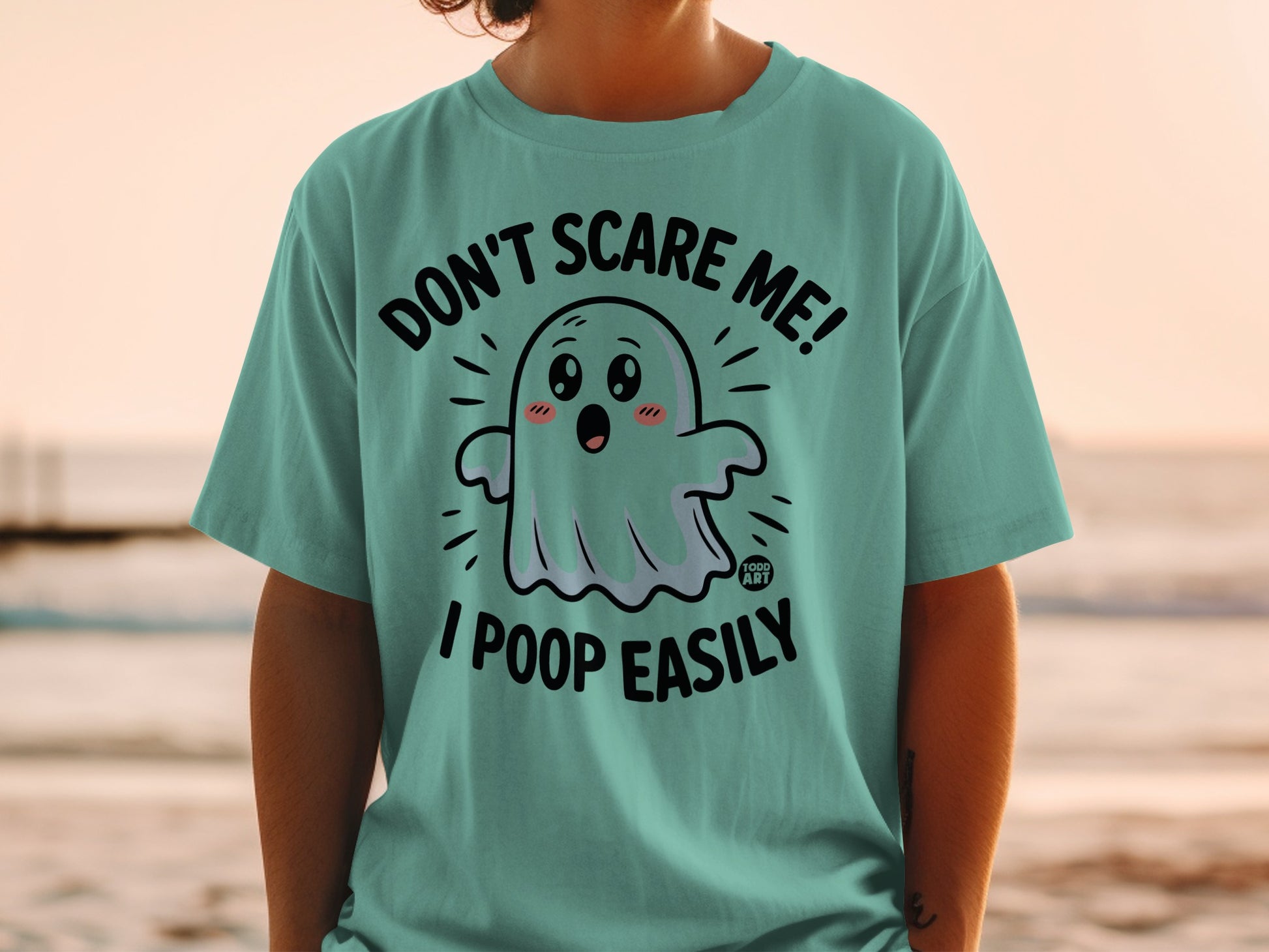 Teal t-shirt with ghost graphic and text "DON'T SCARE ME! I POOP EASILY".