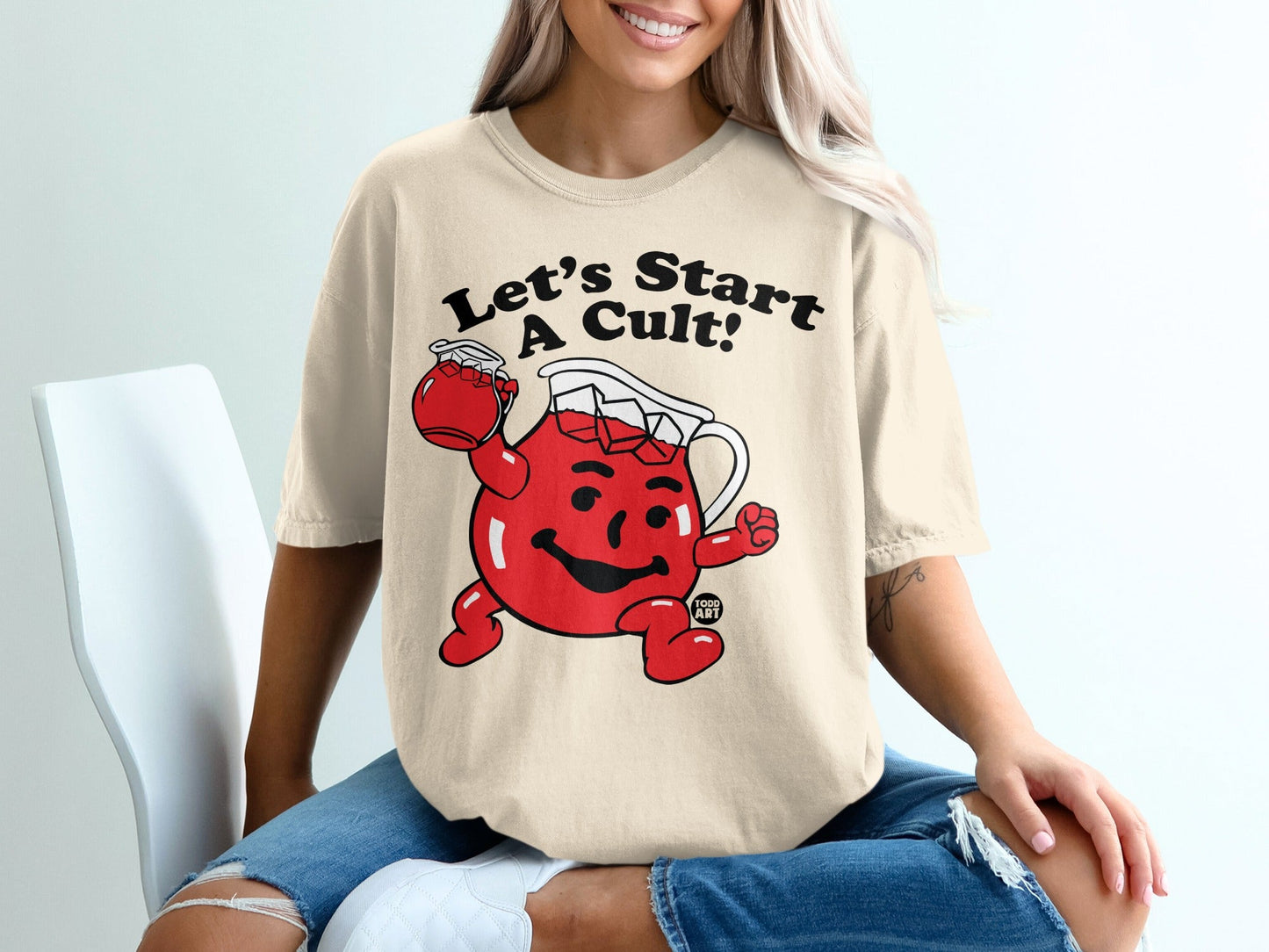 Kool-Aid Man character on a tan t-shirt that says "Let's Start A Cult!"