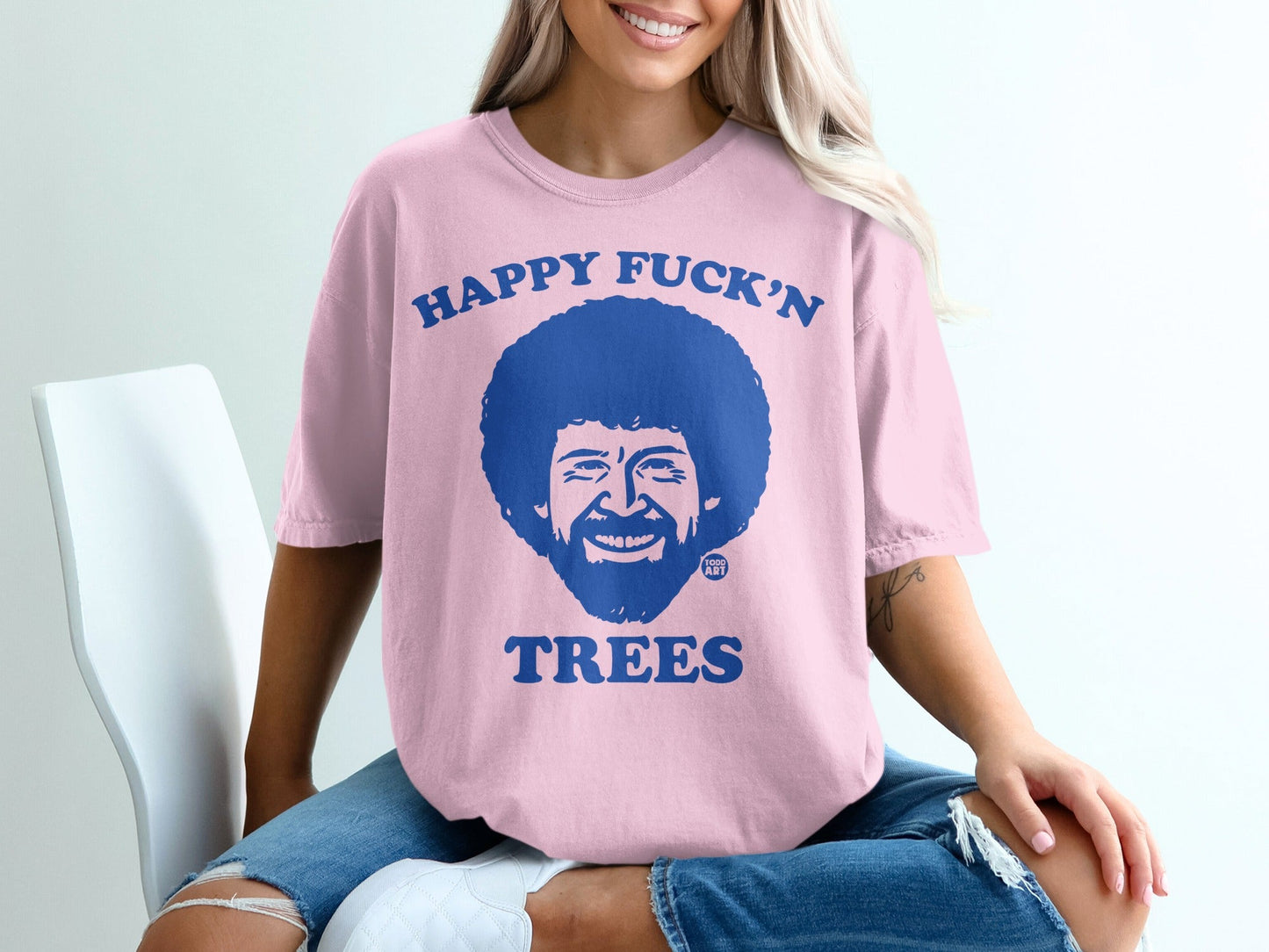 Pink t-shirt with Bob Ross and "Happy Fuck'n Trees" text.