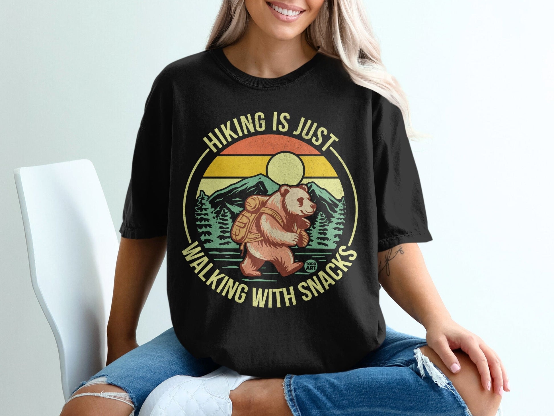 Black t-shirt with bear hiking, "Hiking is just walking with snacks" text.
