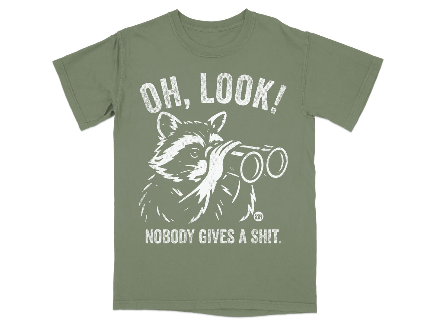 White raccoon wearing glasses looks through binoculars on a green t-shirt with text.