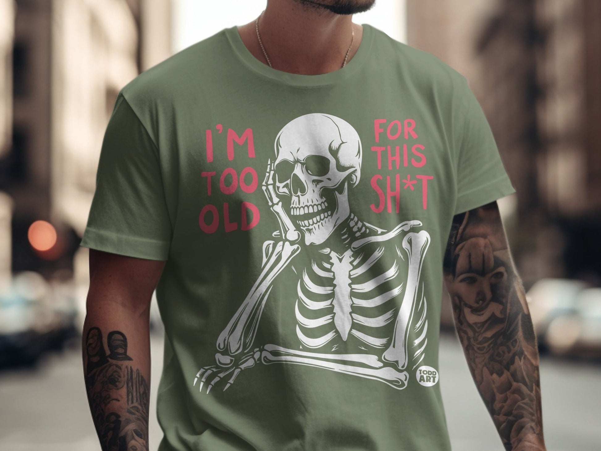 Olive t-shirt with a skeleton graphic and text "I'm TOO OLD FOR THIS SH*T".