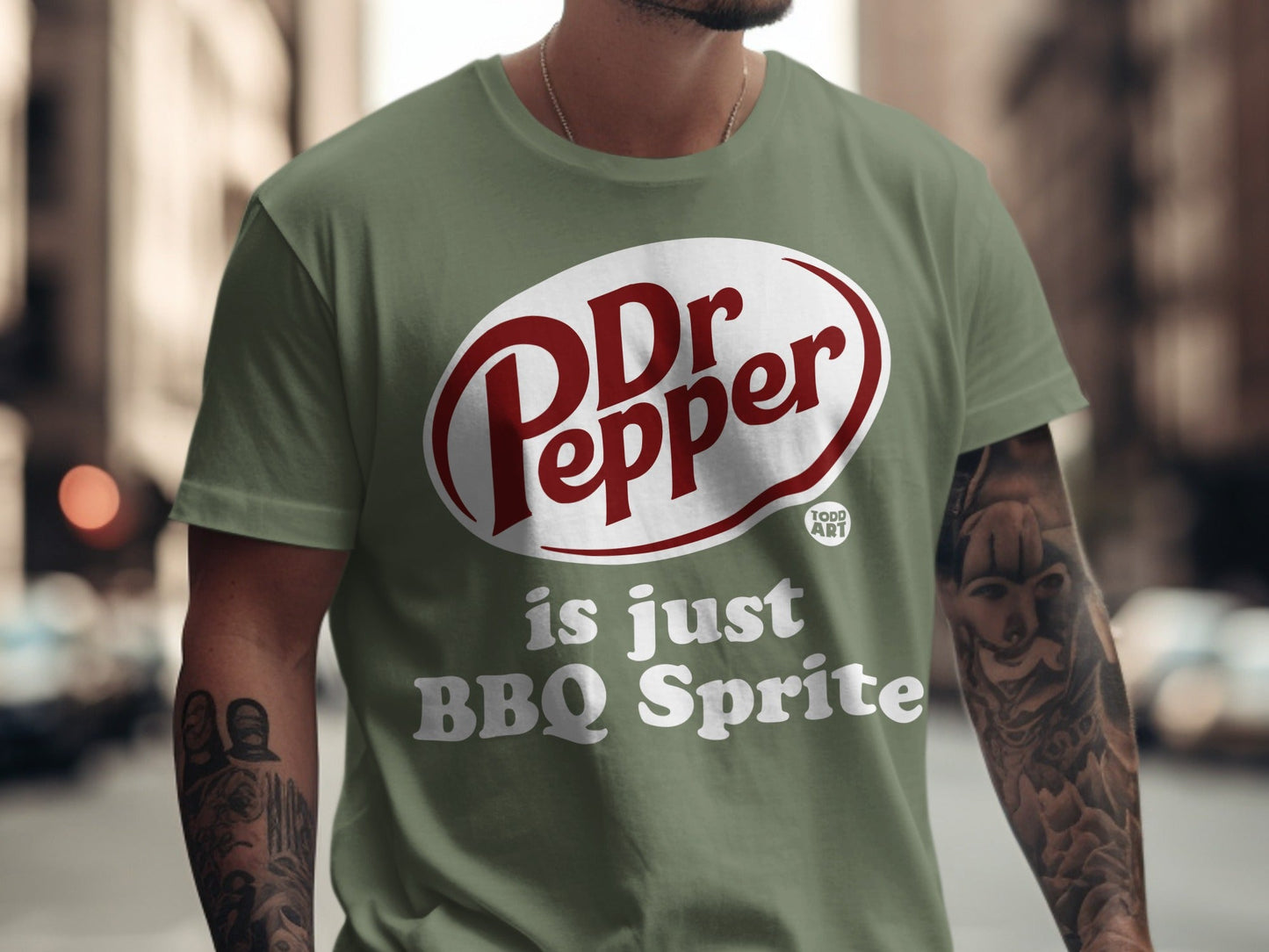 Green t-shirt with "Dr Pepper is just BBQ Sprite" text.