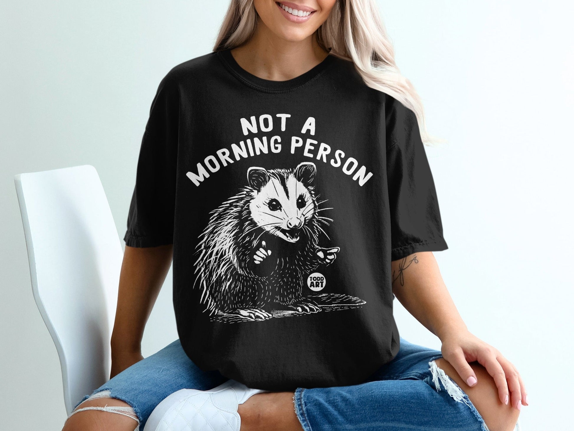 Black t-shirt with opossum and "Not a Morning Person" text.