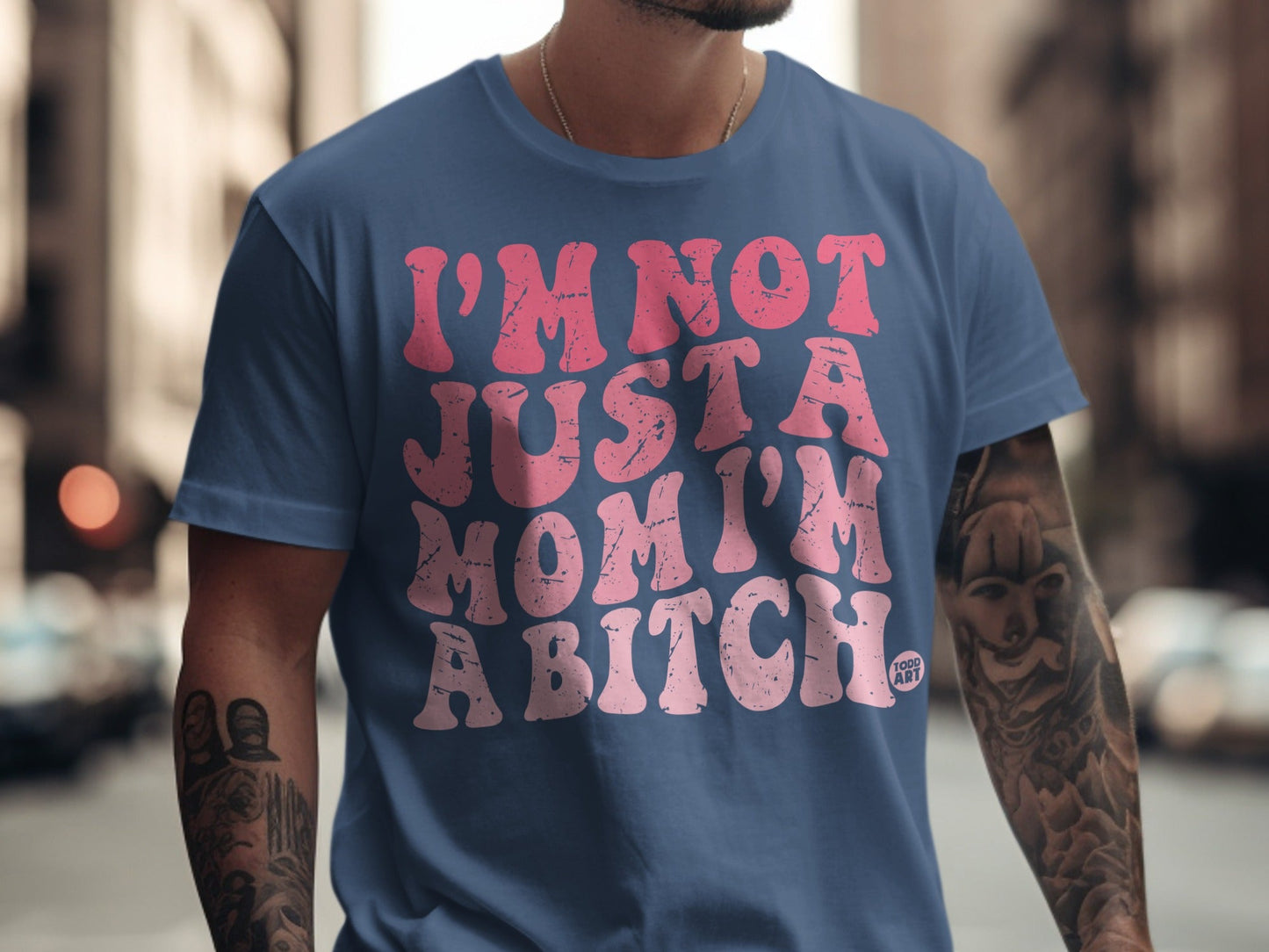 Blue t-shirt with "I'm not just a mom, I'm a bitch" in pink lettering.