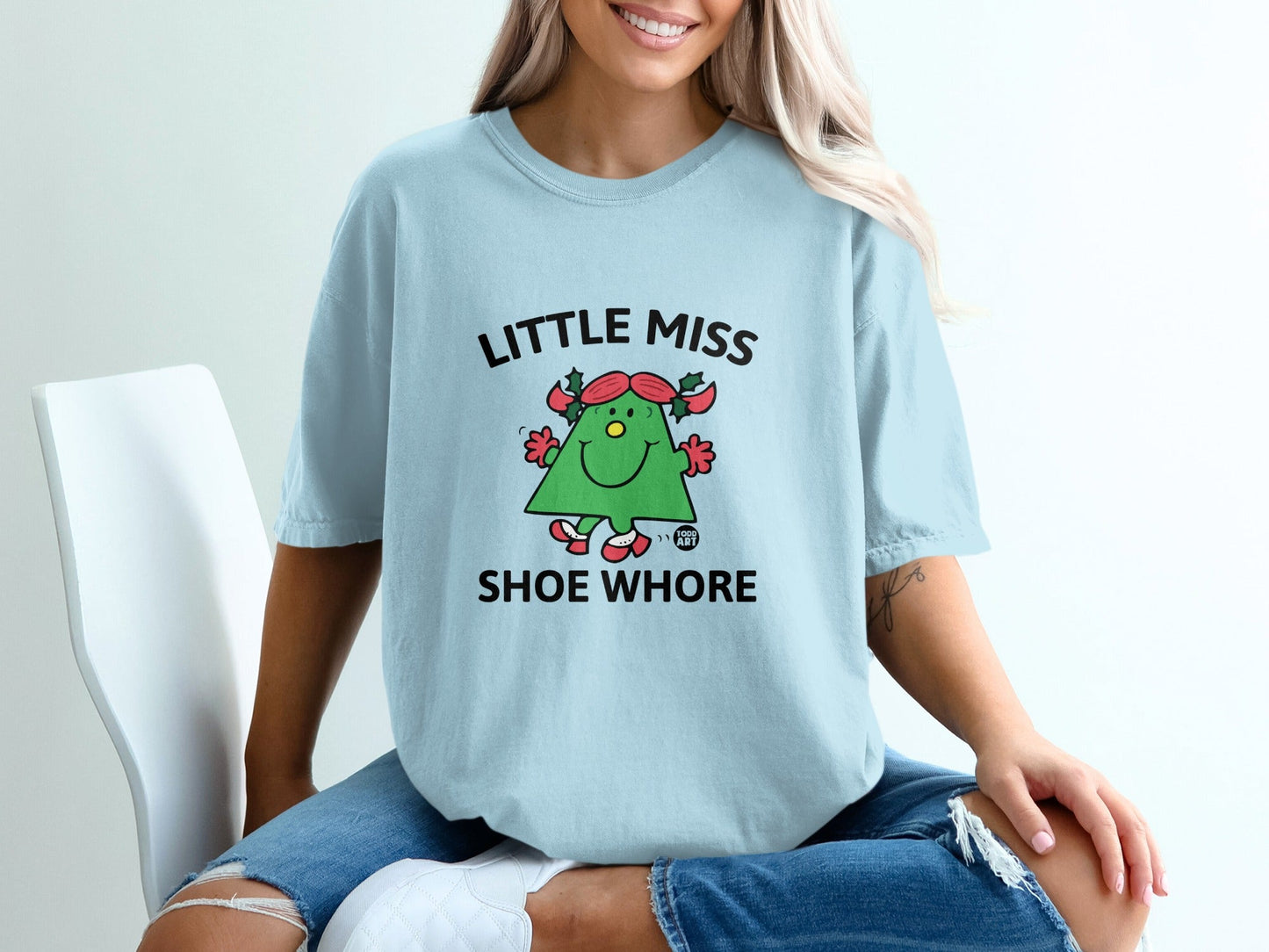 Light blue t-shirt with "Little Miss Shoe Whore" text and cartoon shoe character.